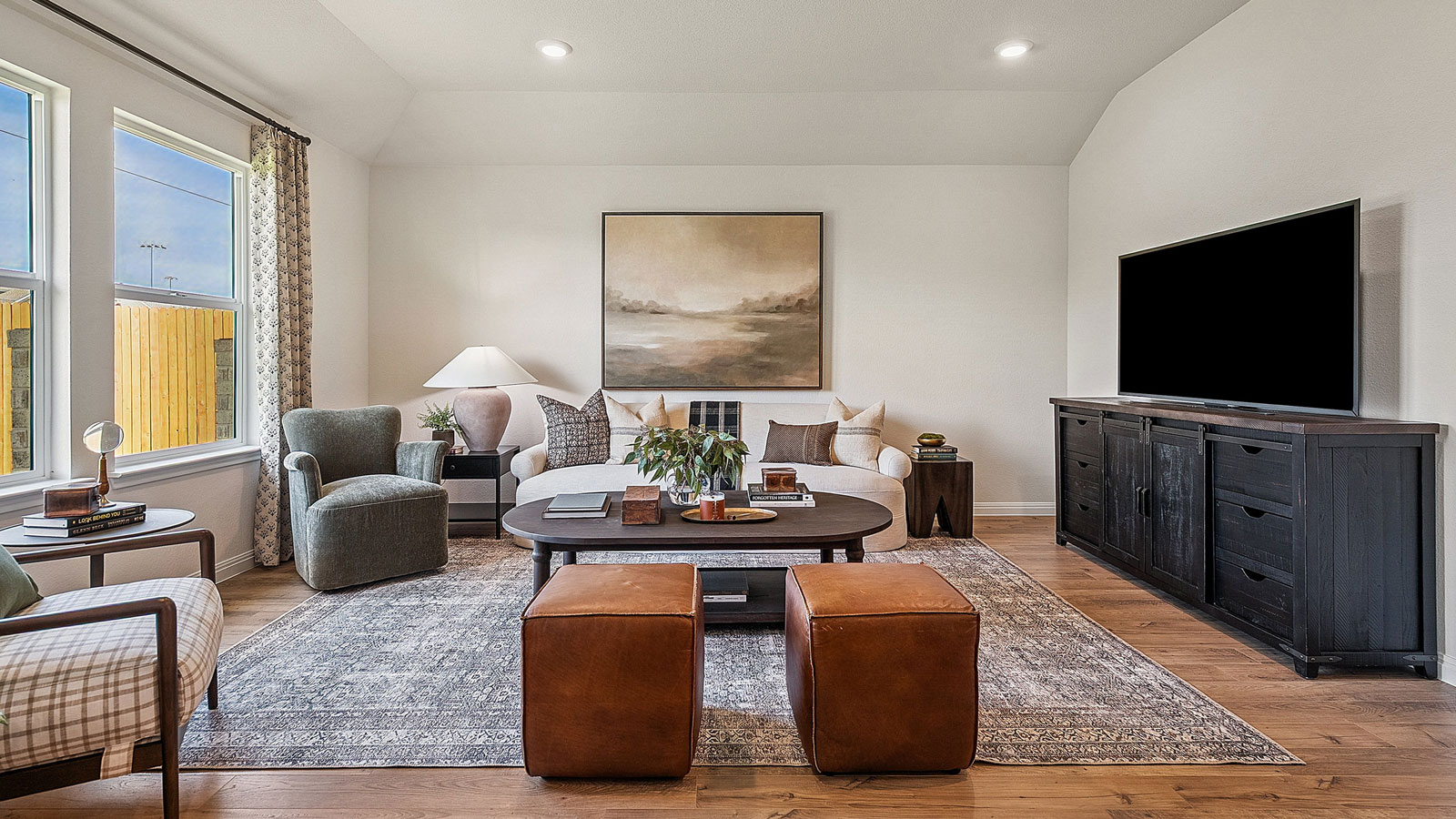 Living area with simple furnishings and an area rug.