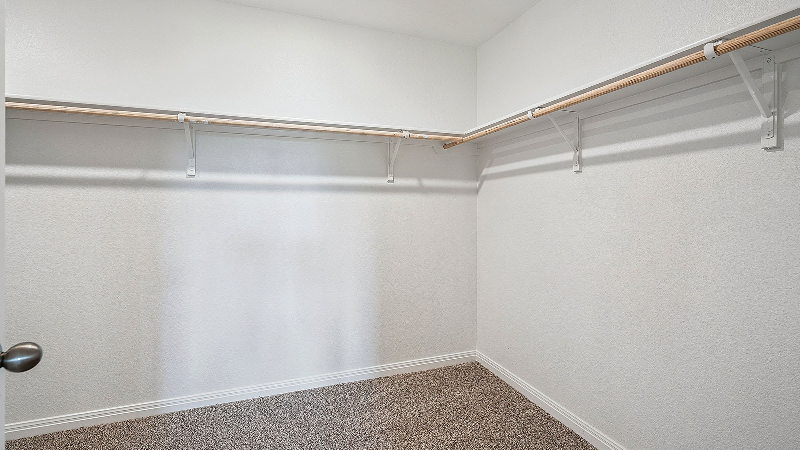 Spacious walk in closet with hanging rod