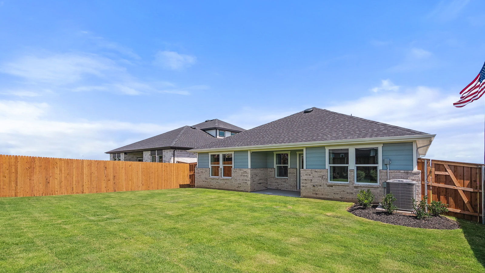 Fenced in, manicured lawn with room for entertainment.