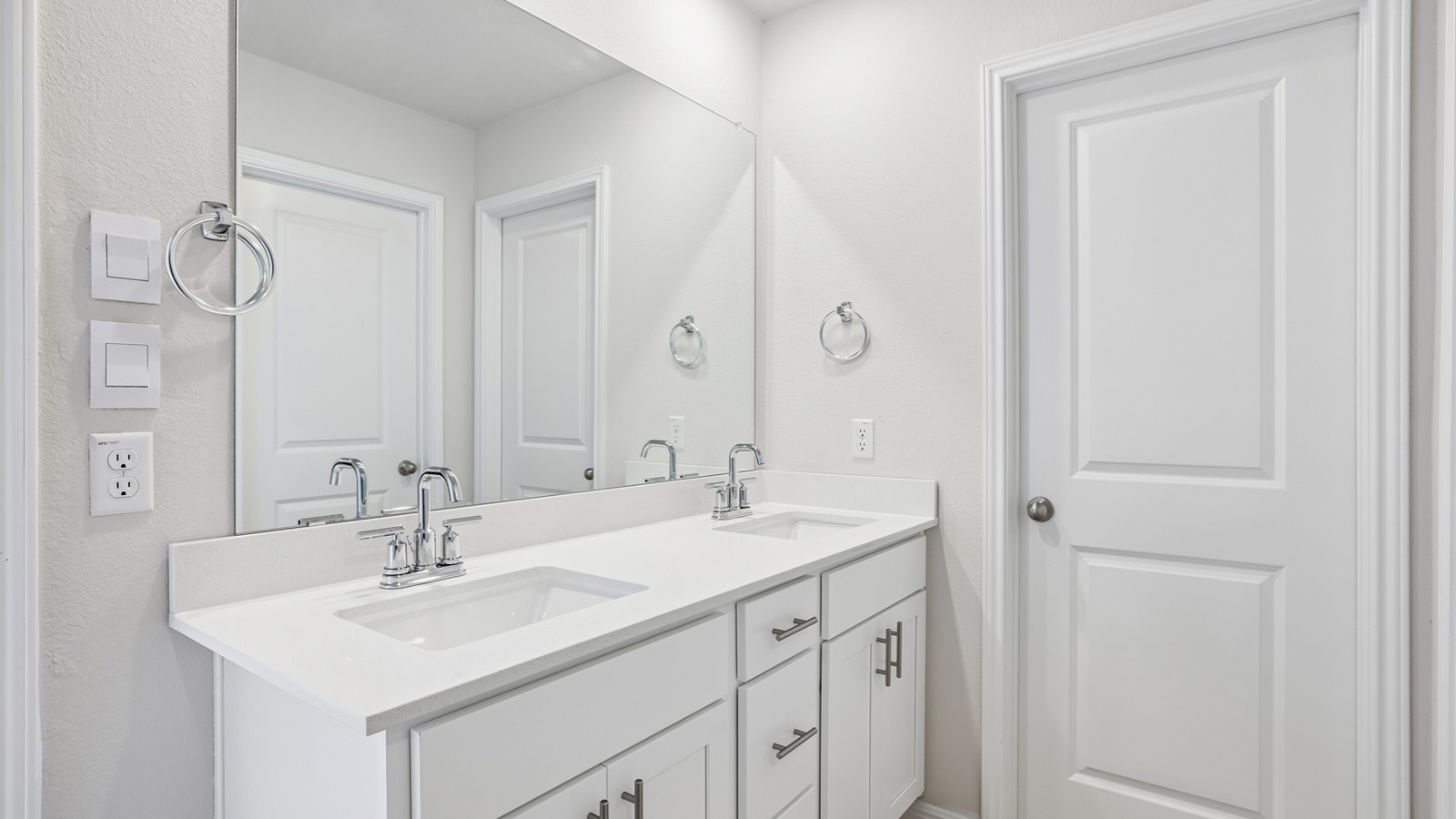 Quartz double vanity sink in primary bathroom.
