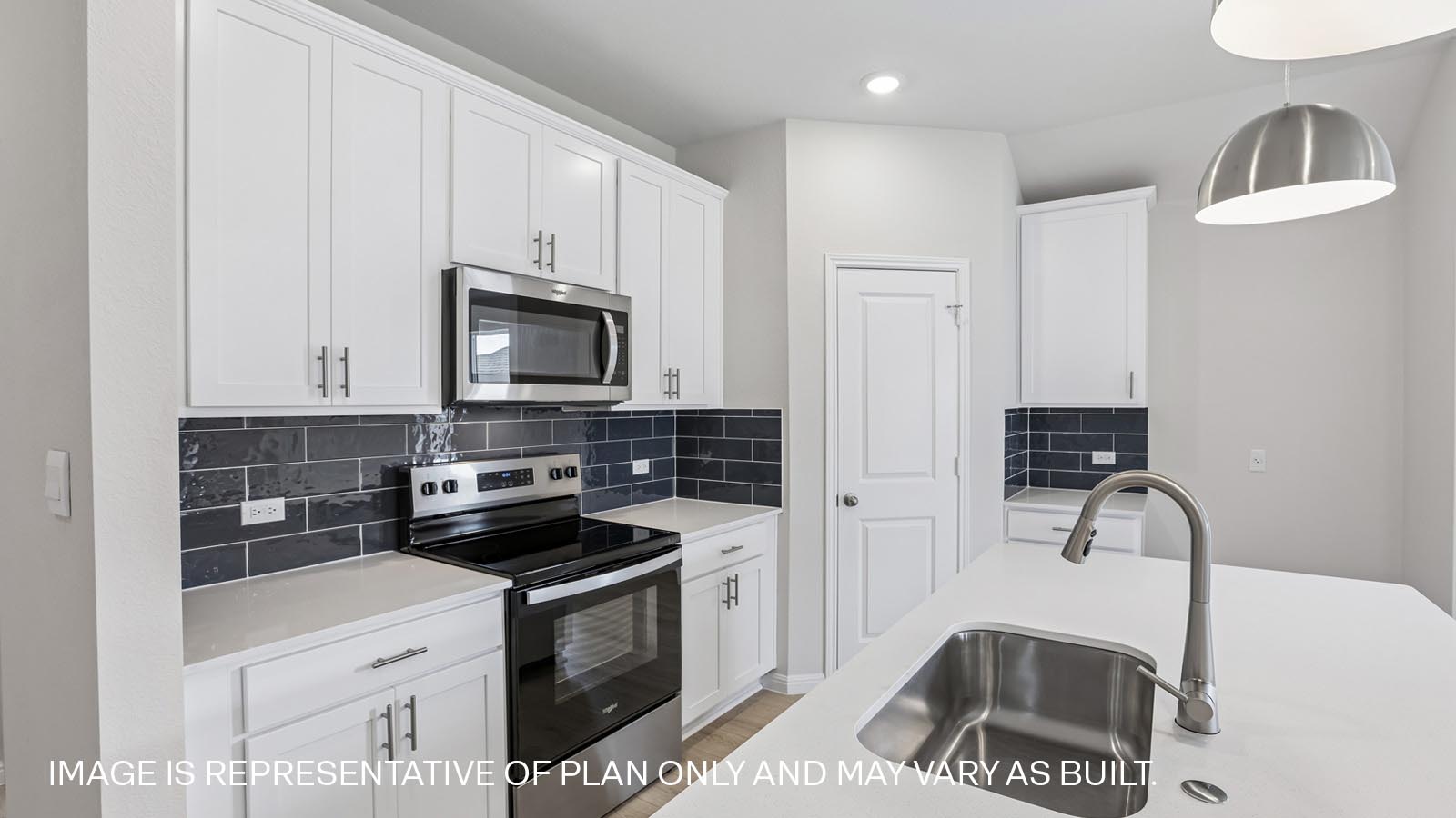 Stainless steel range, microwave and tile backsplash.