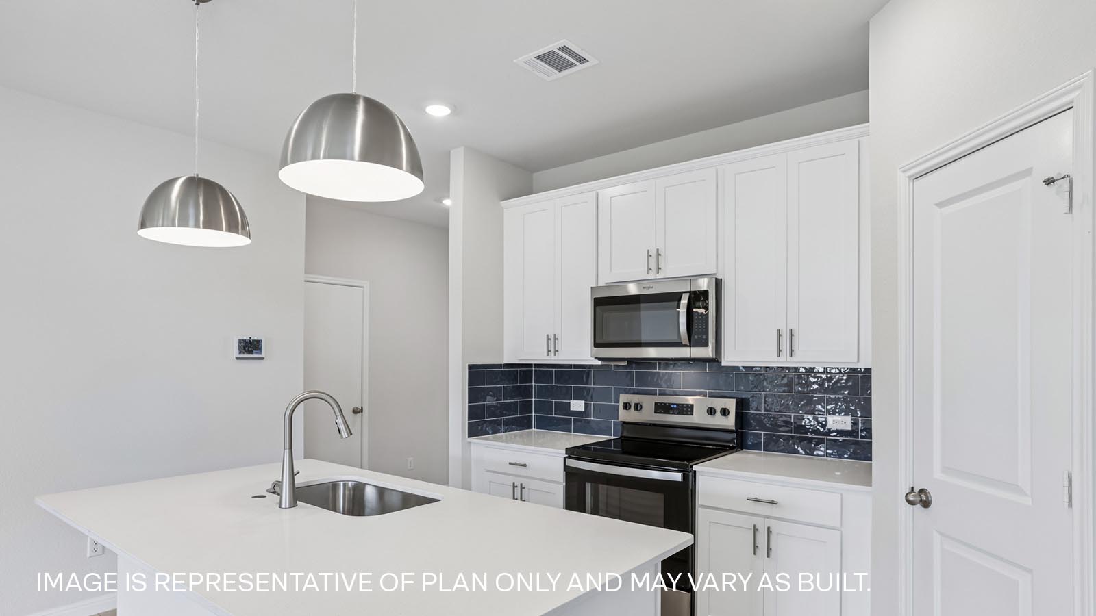 Stainless steel range, microwave and tile backsplash.