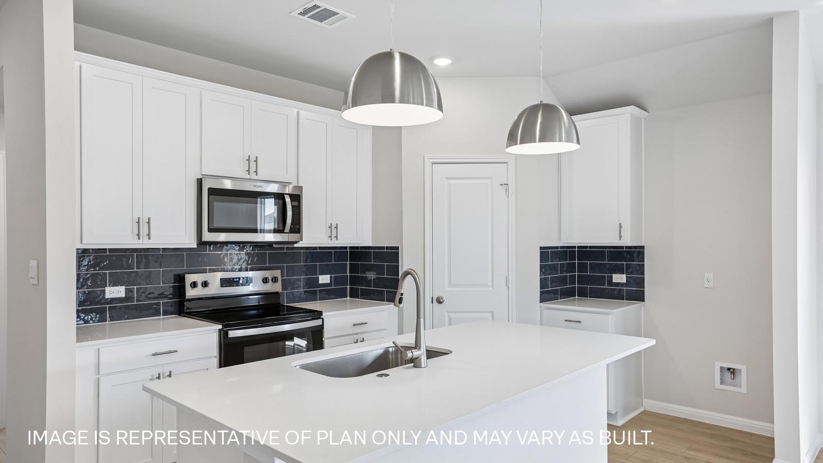 Stainless steel range, microwave and tile backsplash.