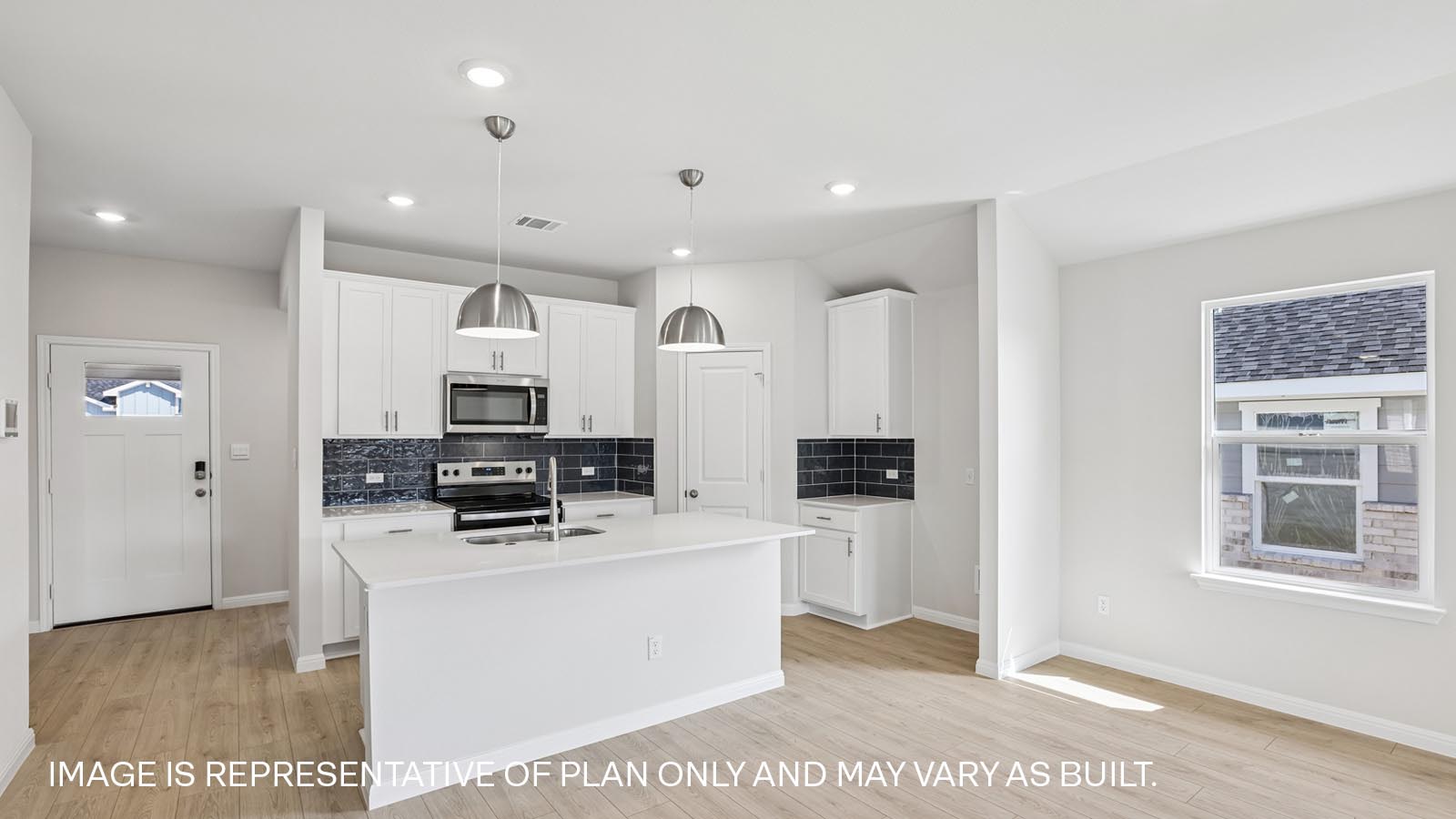 Stainless steel range, microwave and tile backsplash.
