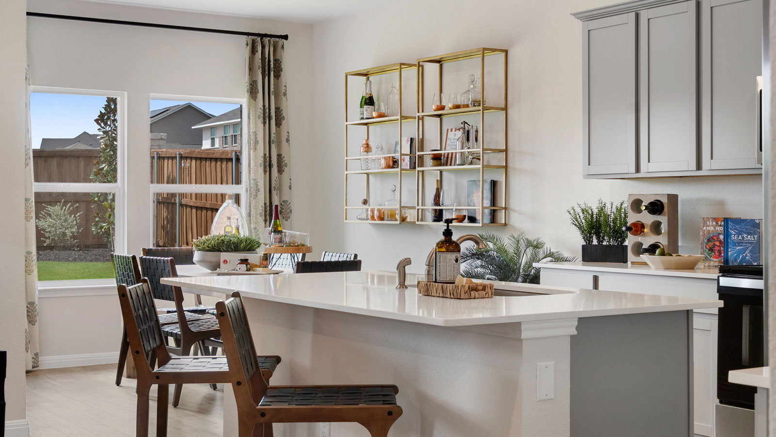 Open concept kitchen area connecting to living and dining space.