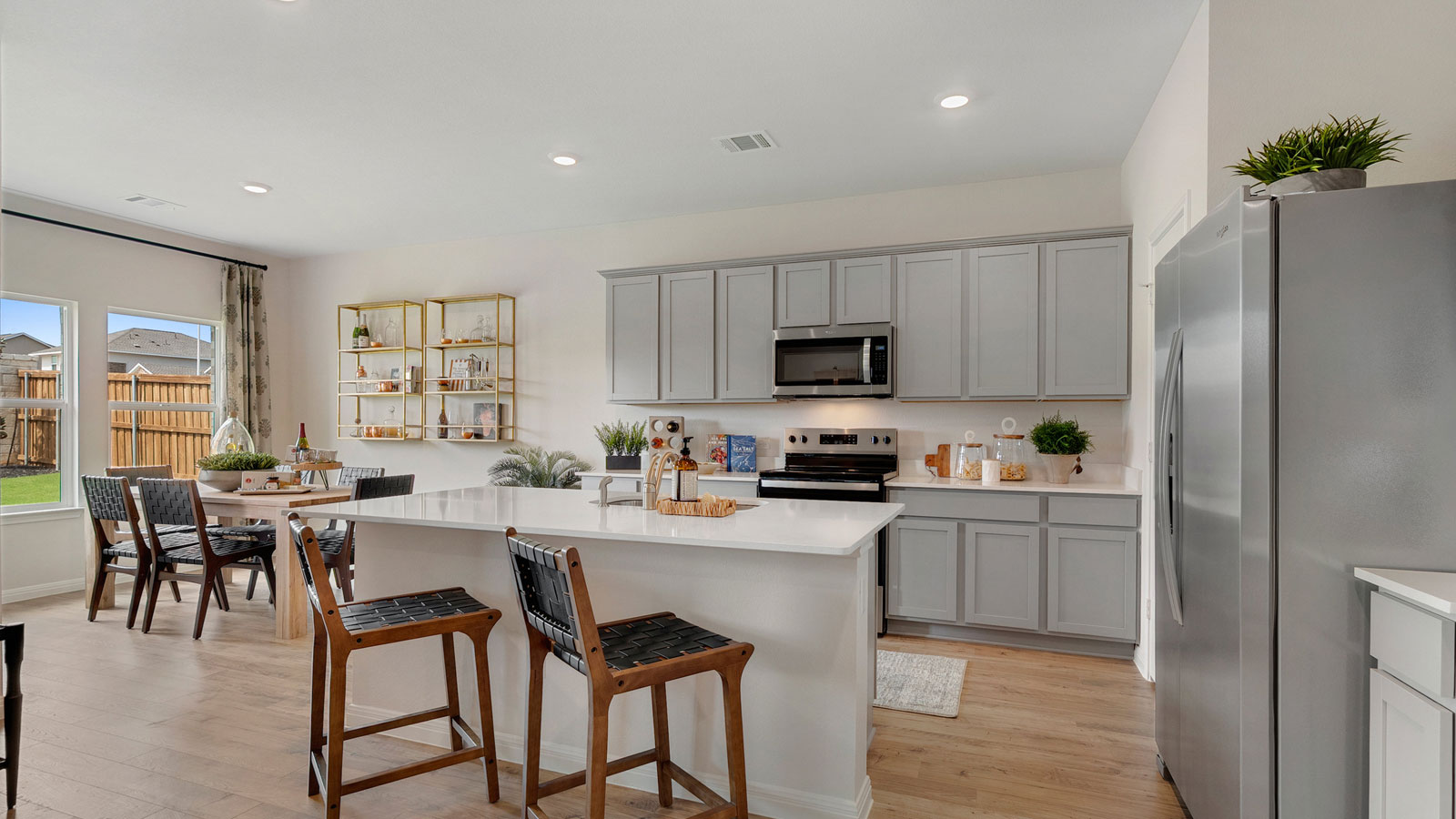 Kitchen featuring cabinets, new stainless steel appliances, and a large standing island.