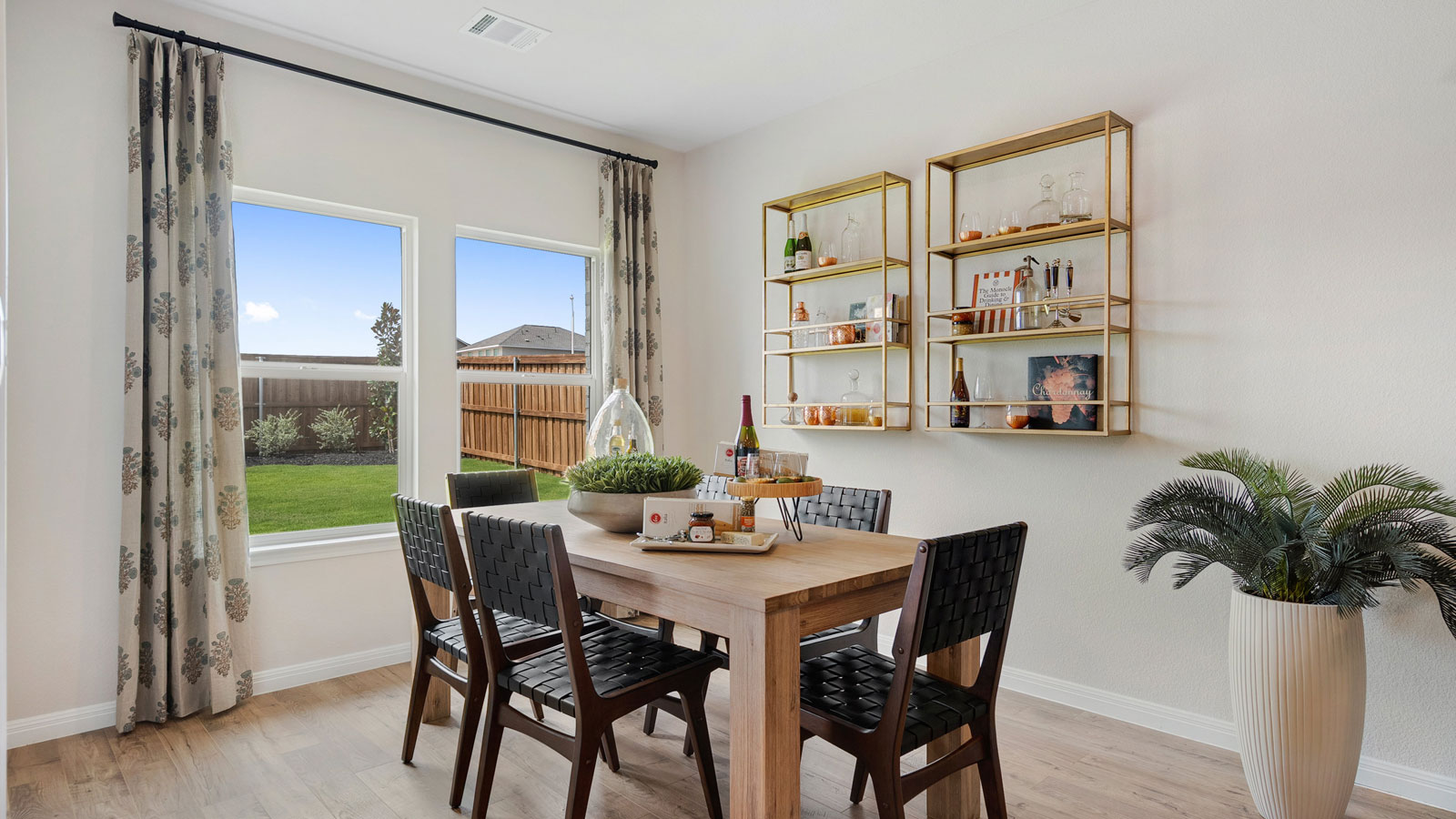 Dining area with table, chairs, and natural lighting.