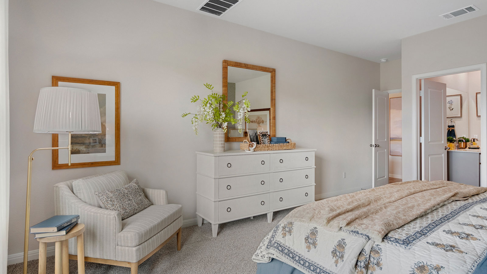 Primary bedroom with neutral walls, carpet, and natural lighting.