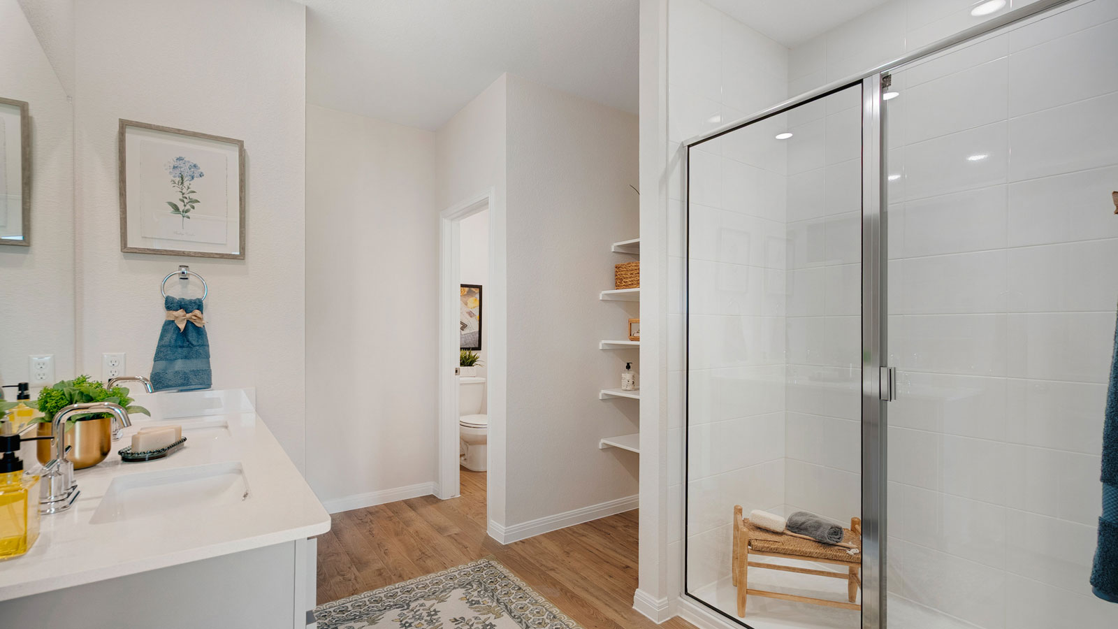 Bathroom with dual sinks and a walk in shower.