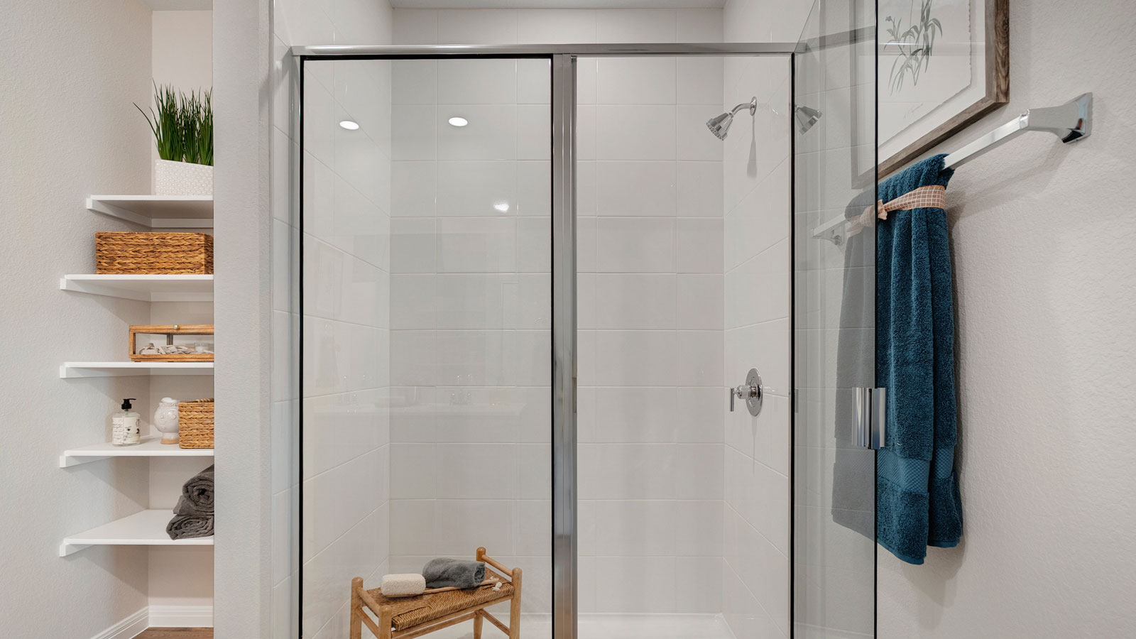 Bathroom featuring a walk in shower and built in shelving.