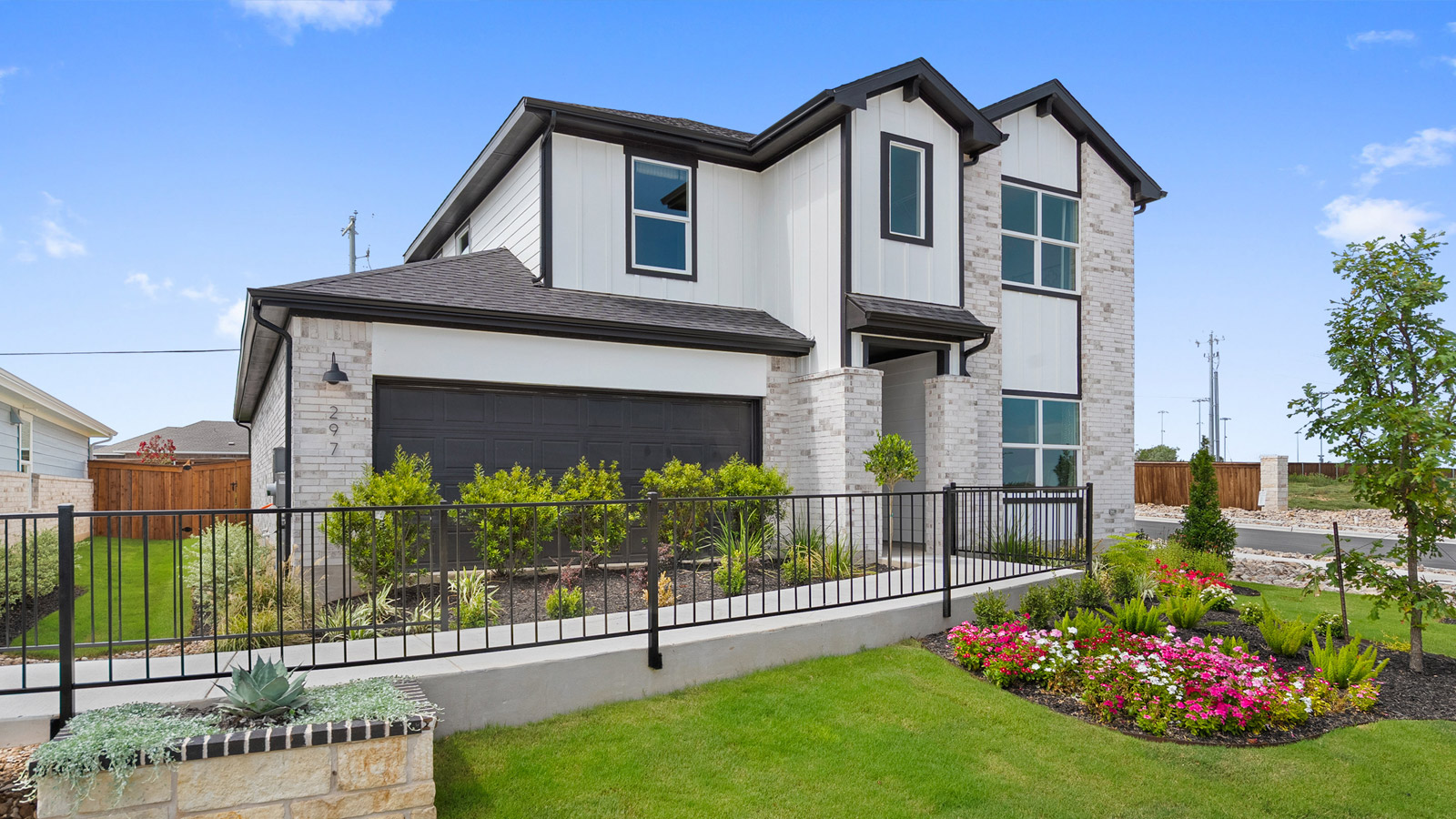 Modern suburban home with neutral exterior and stone accents.