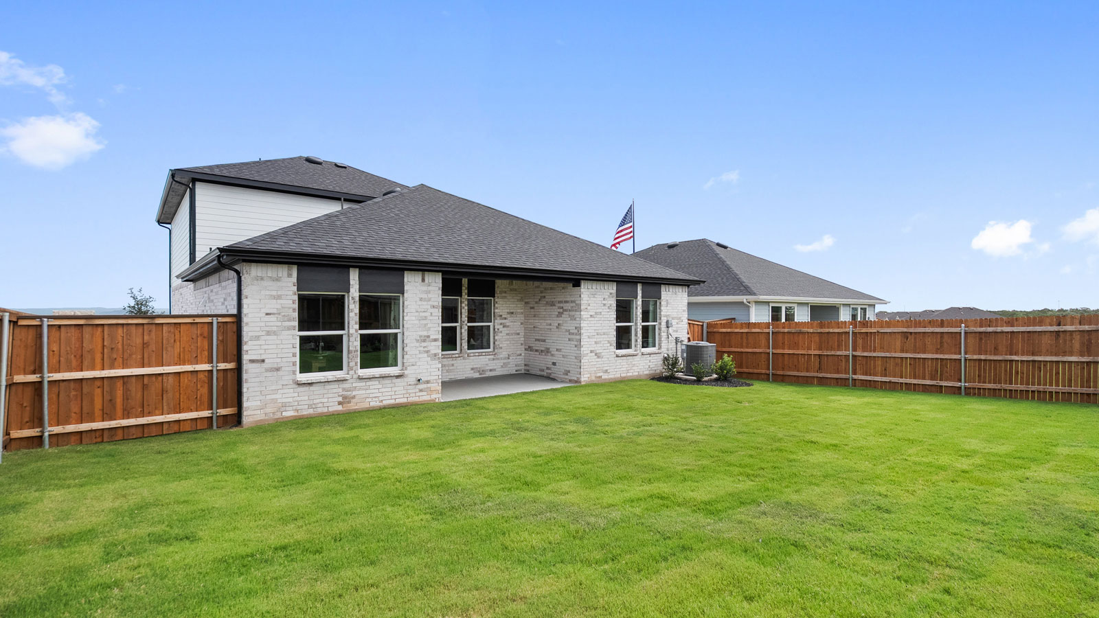 Fenced in, manicured lawn with room for entertainment.