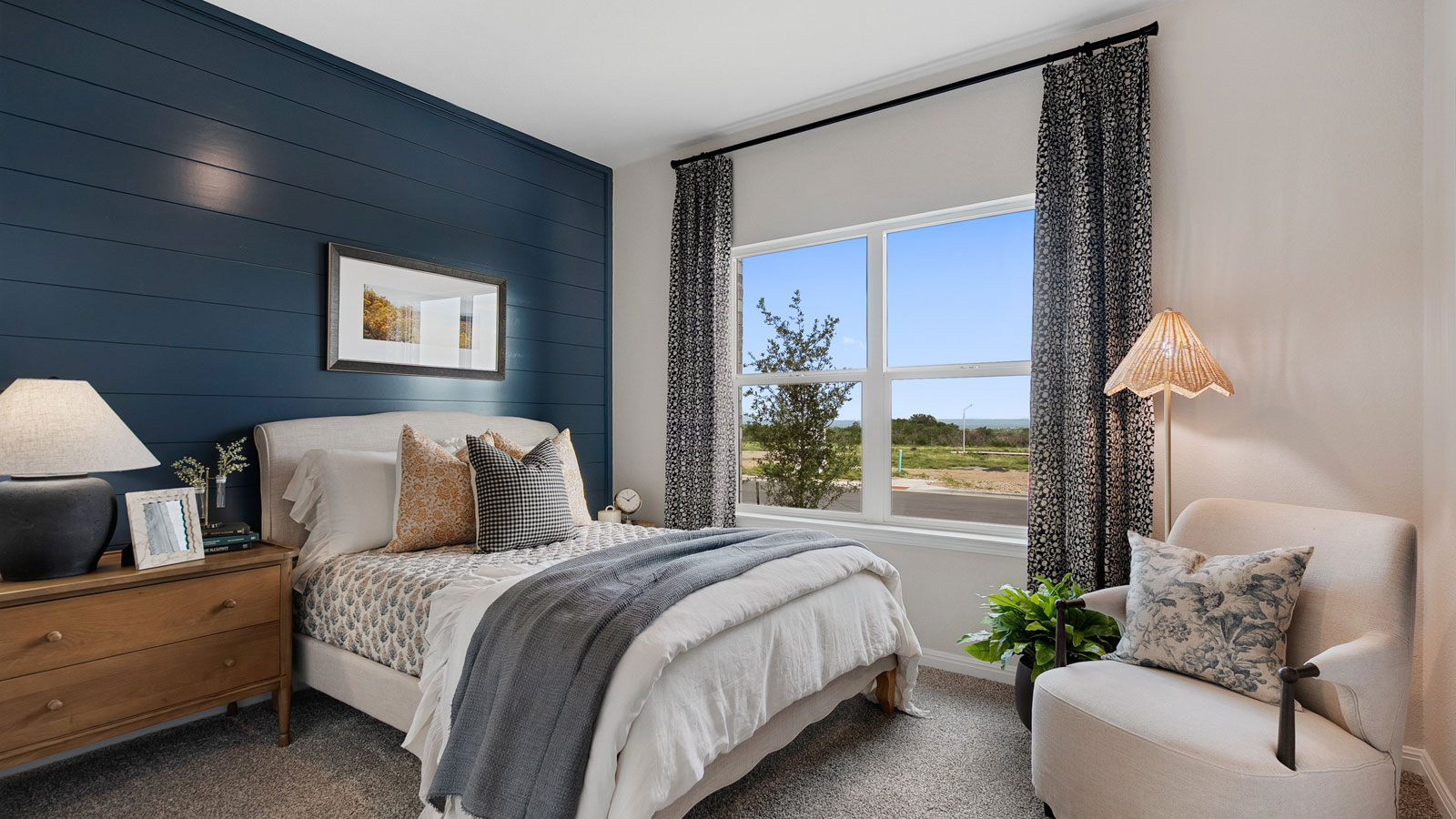 Bedroom with an accent wall and natural lighting.