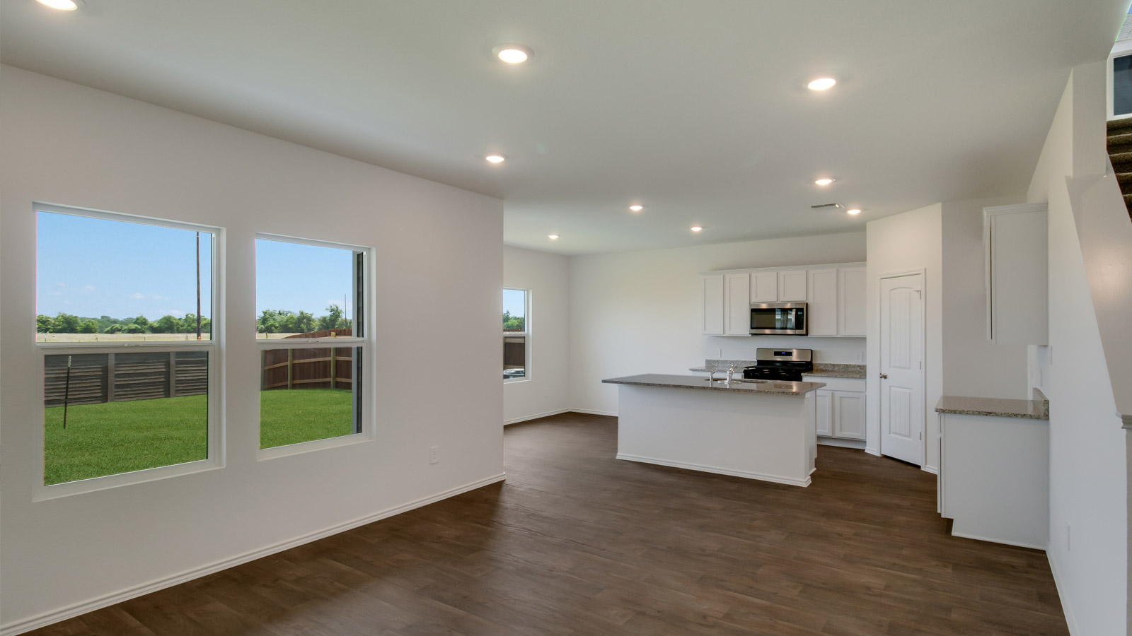 Open-concept kitchen with laminated wood flooring.