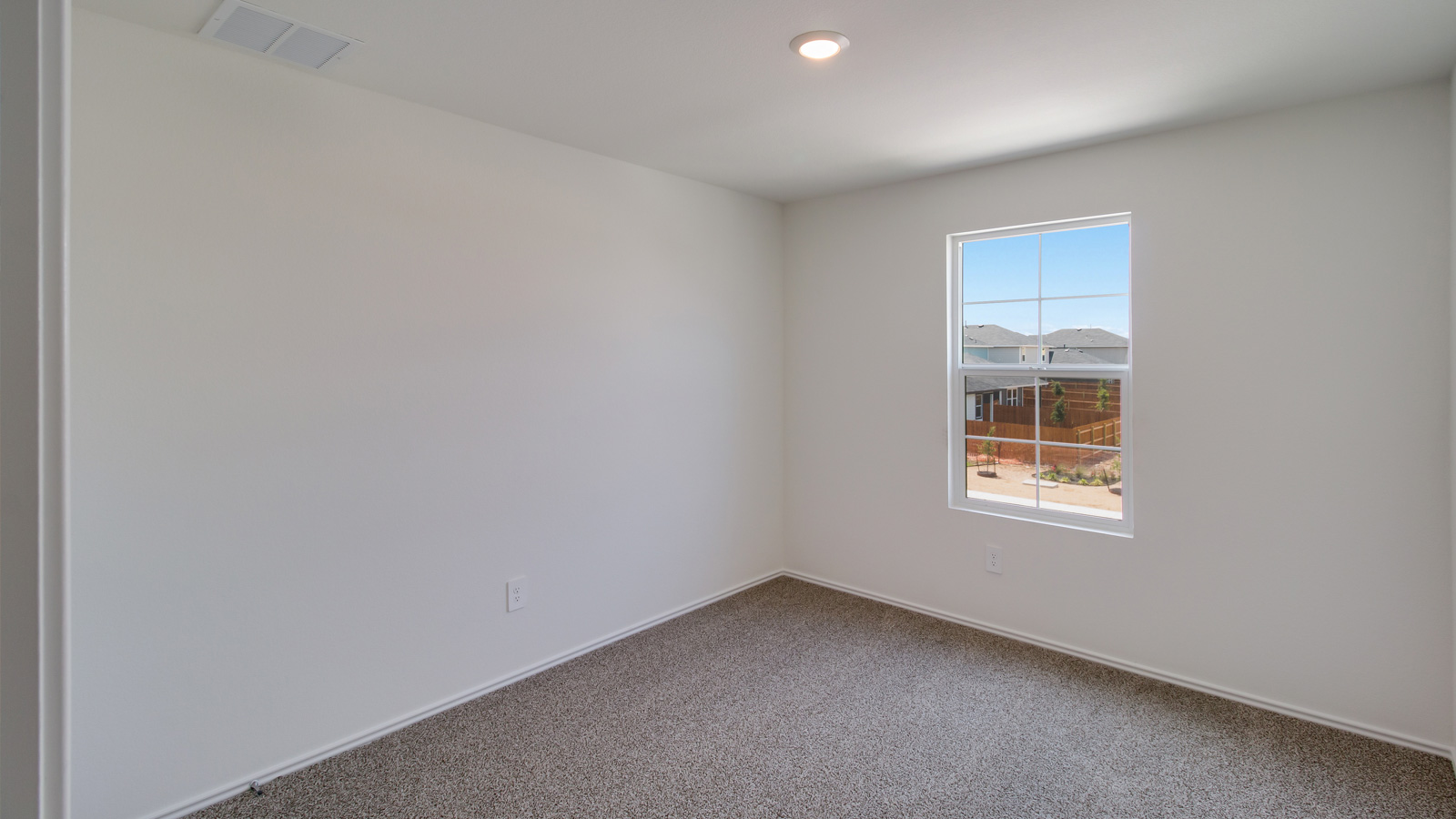Bedroom 3 with carpeted floors and window.
