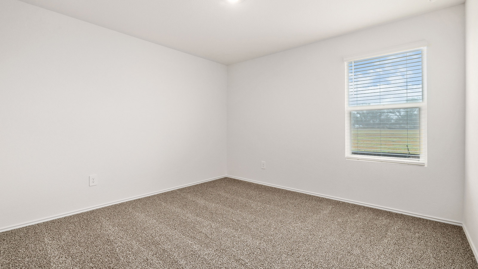Bedroom 2 with carpeted flooring and window.