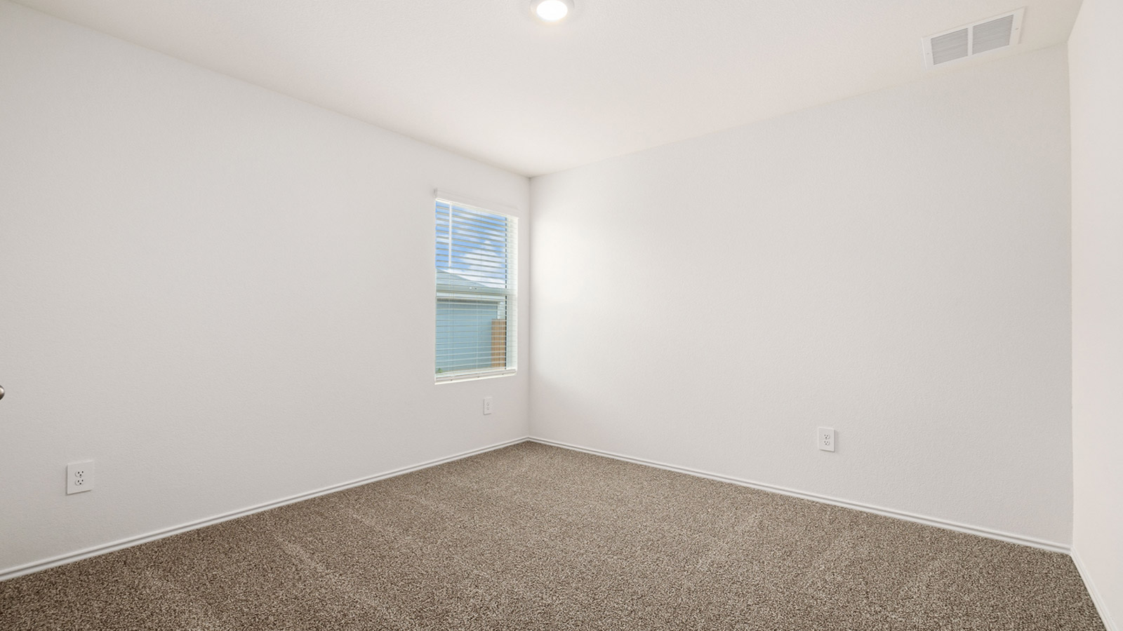 Bedroom 3 with carpeted flooring and window.