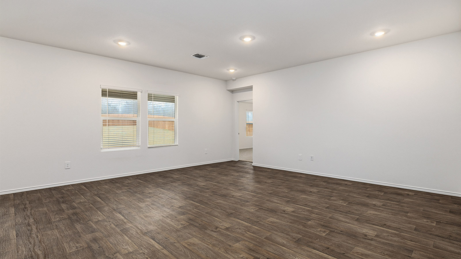 Open concept living area with windows.