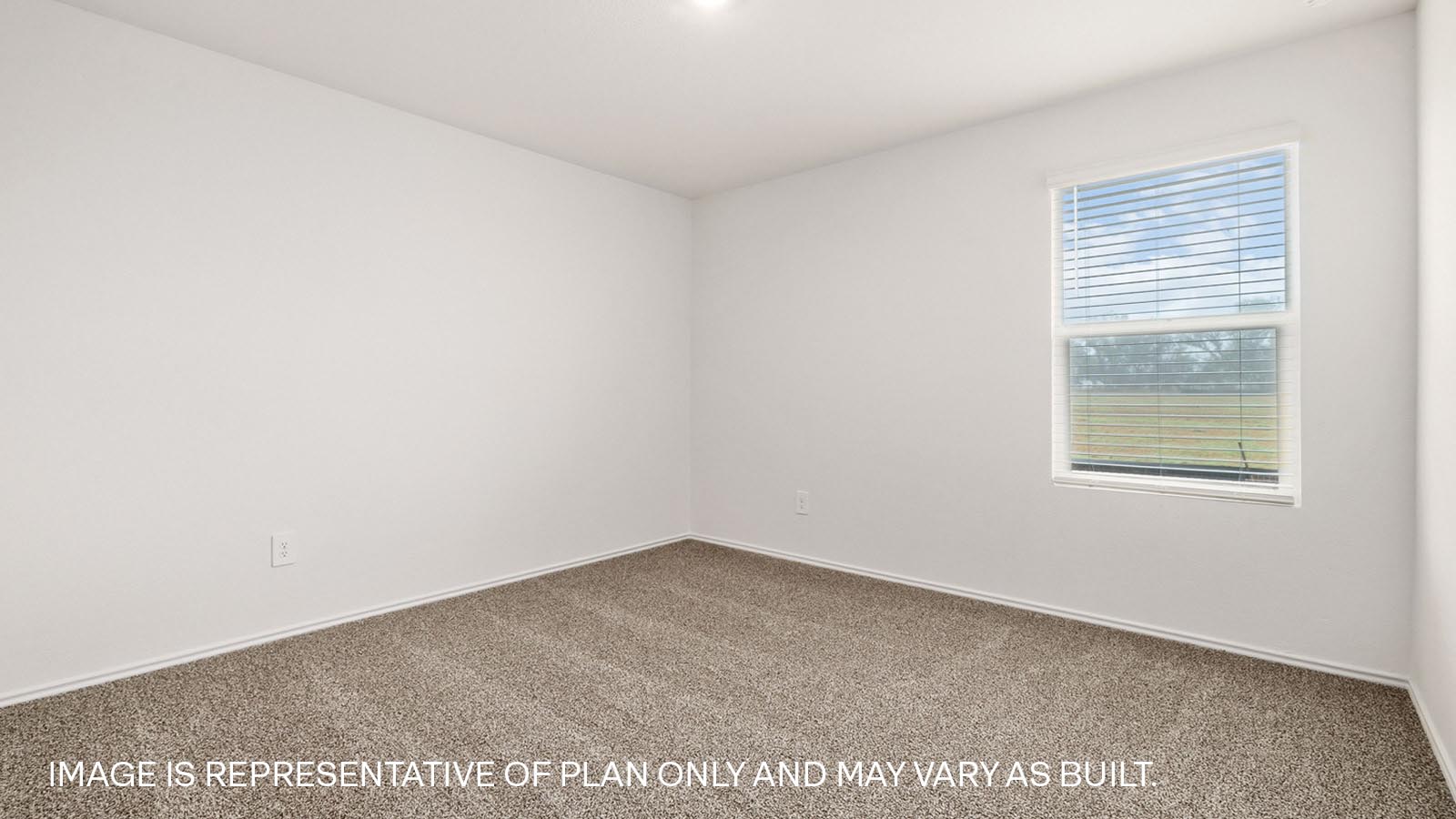 Bedroom 2 with carpeted flooring and window.