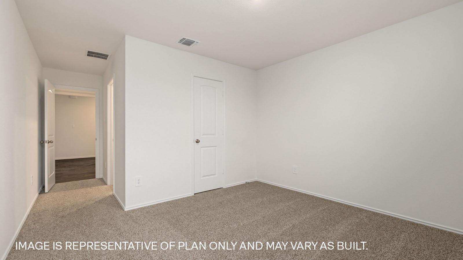 Bedroom 2 with carpeted flooring and window.