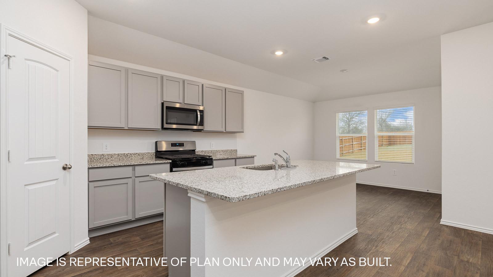 Kitchen with granite countertops and view of backyard.