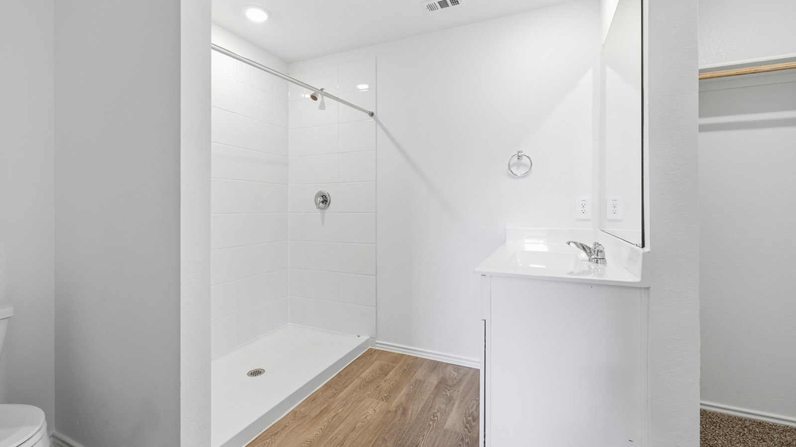 Main bathroom with marble vanity and walk-in shower.
