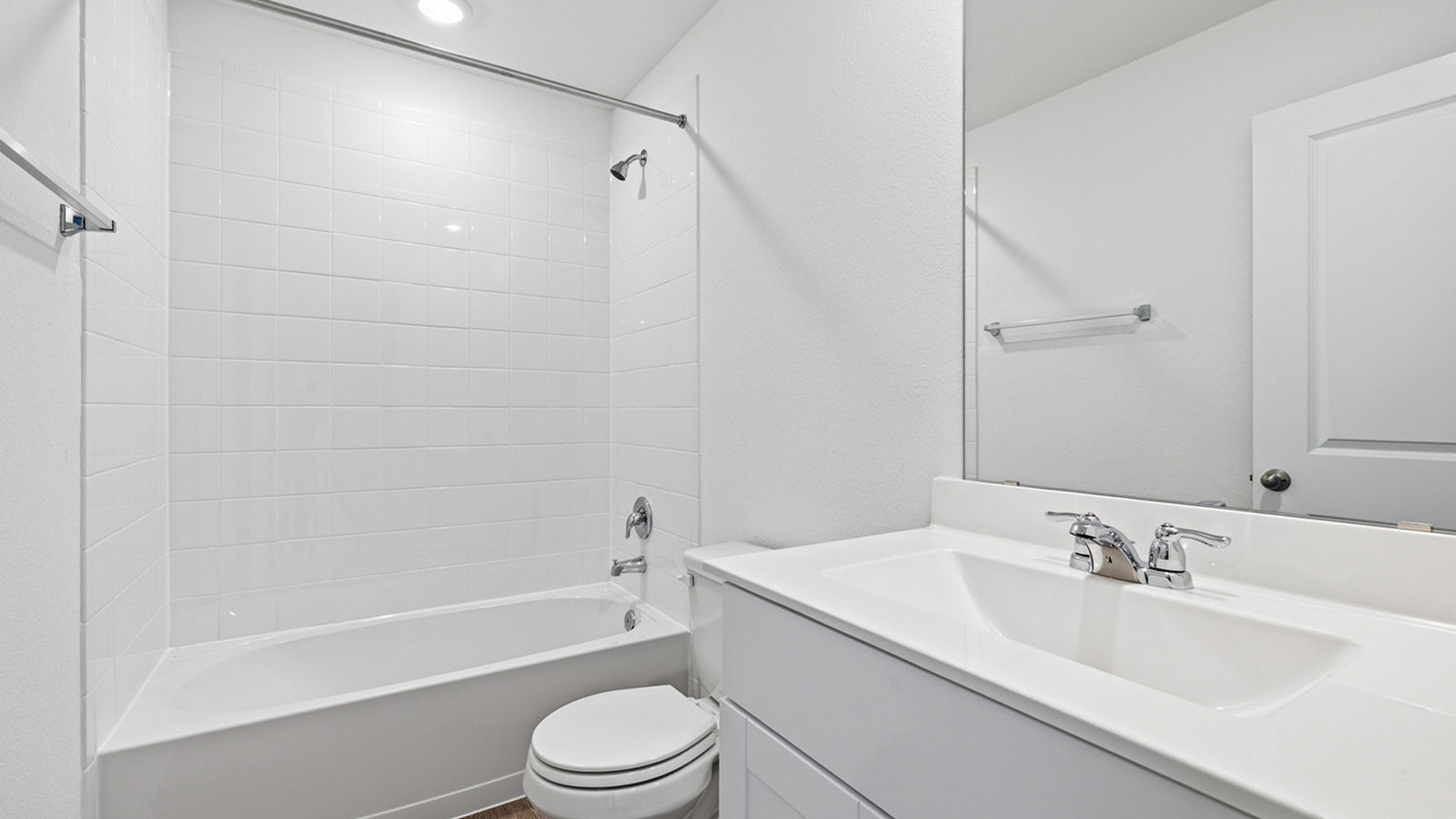 Secondary bathroom with bathtub and raised shower head.