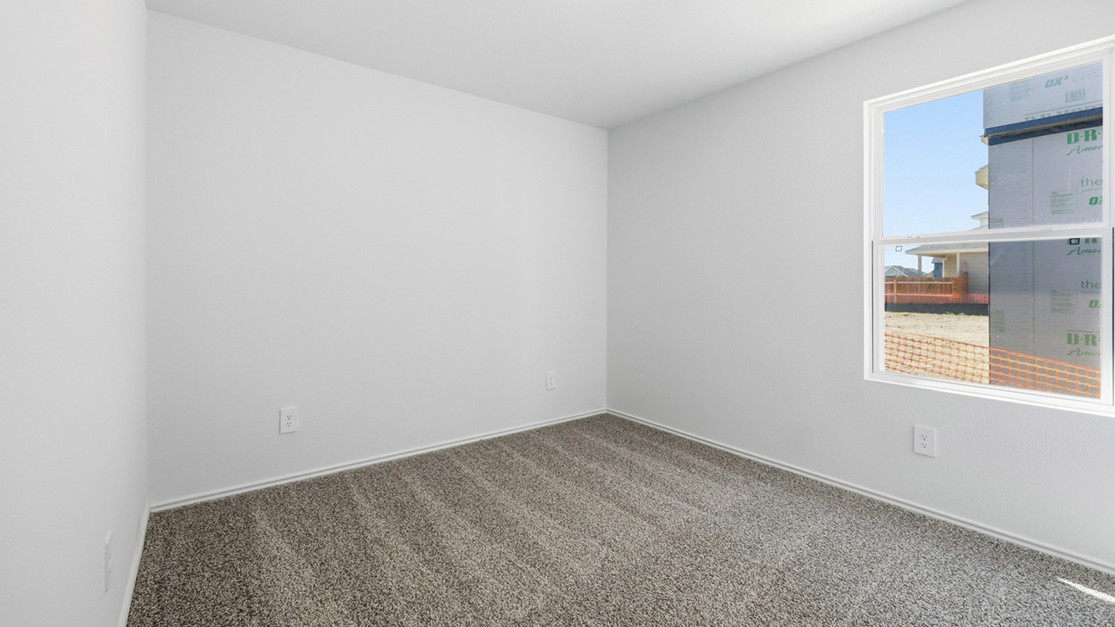 Bedroom 2 with carpeted flooring and window.