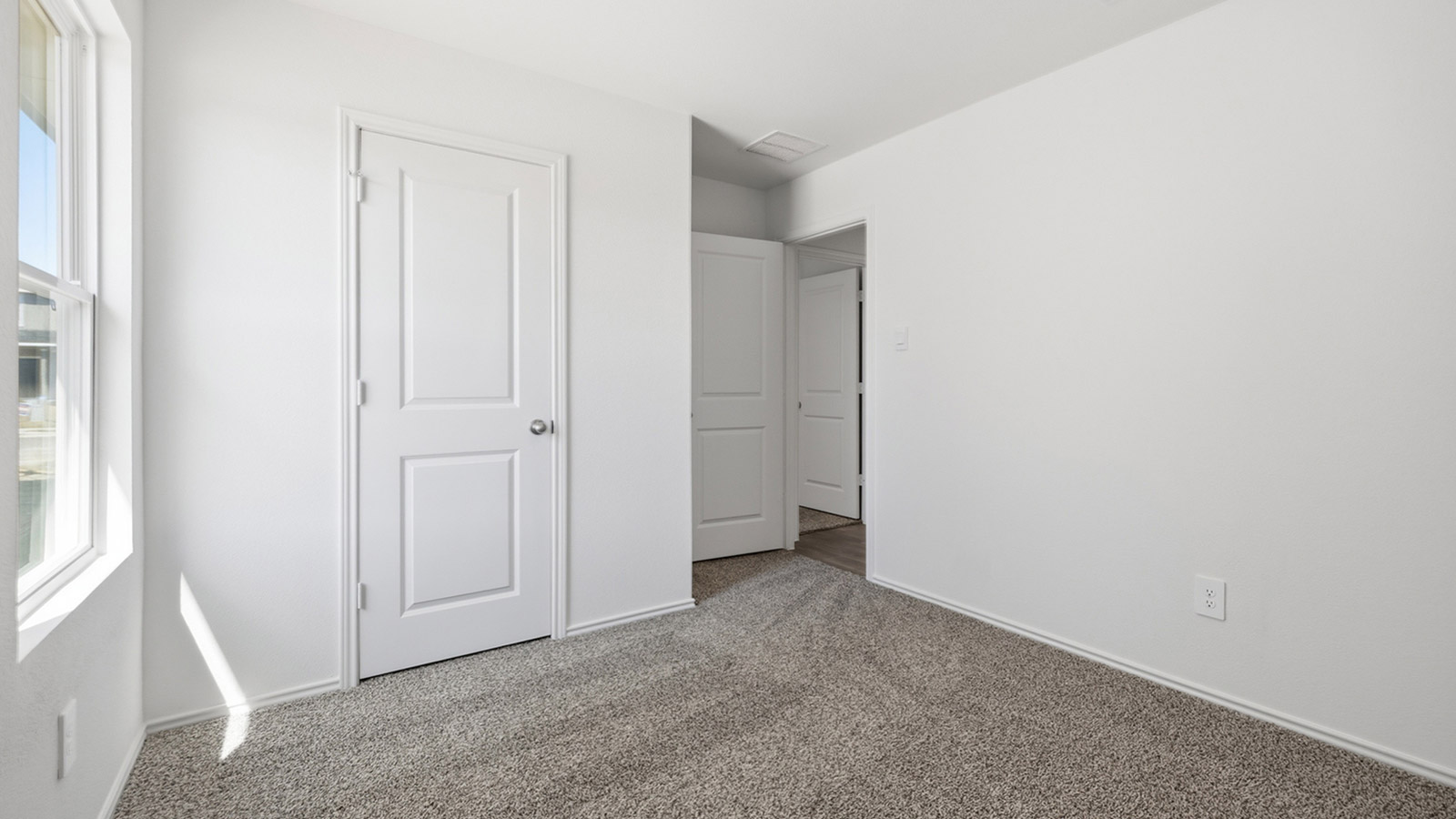 Bedroom 2 with carpeted flooring and storage closet.