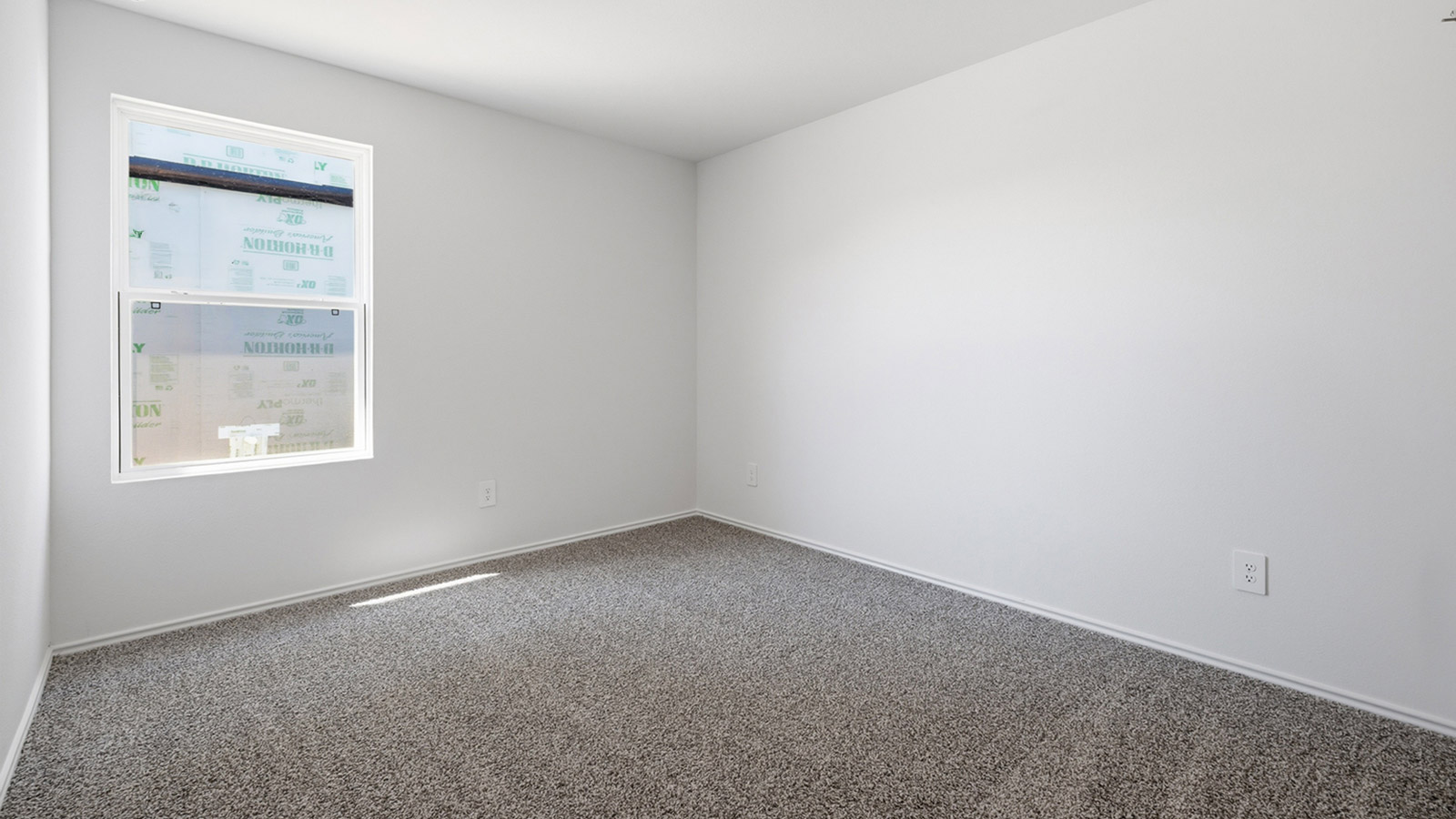 Bedroom 3 with carpeted flooring and window.