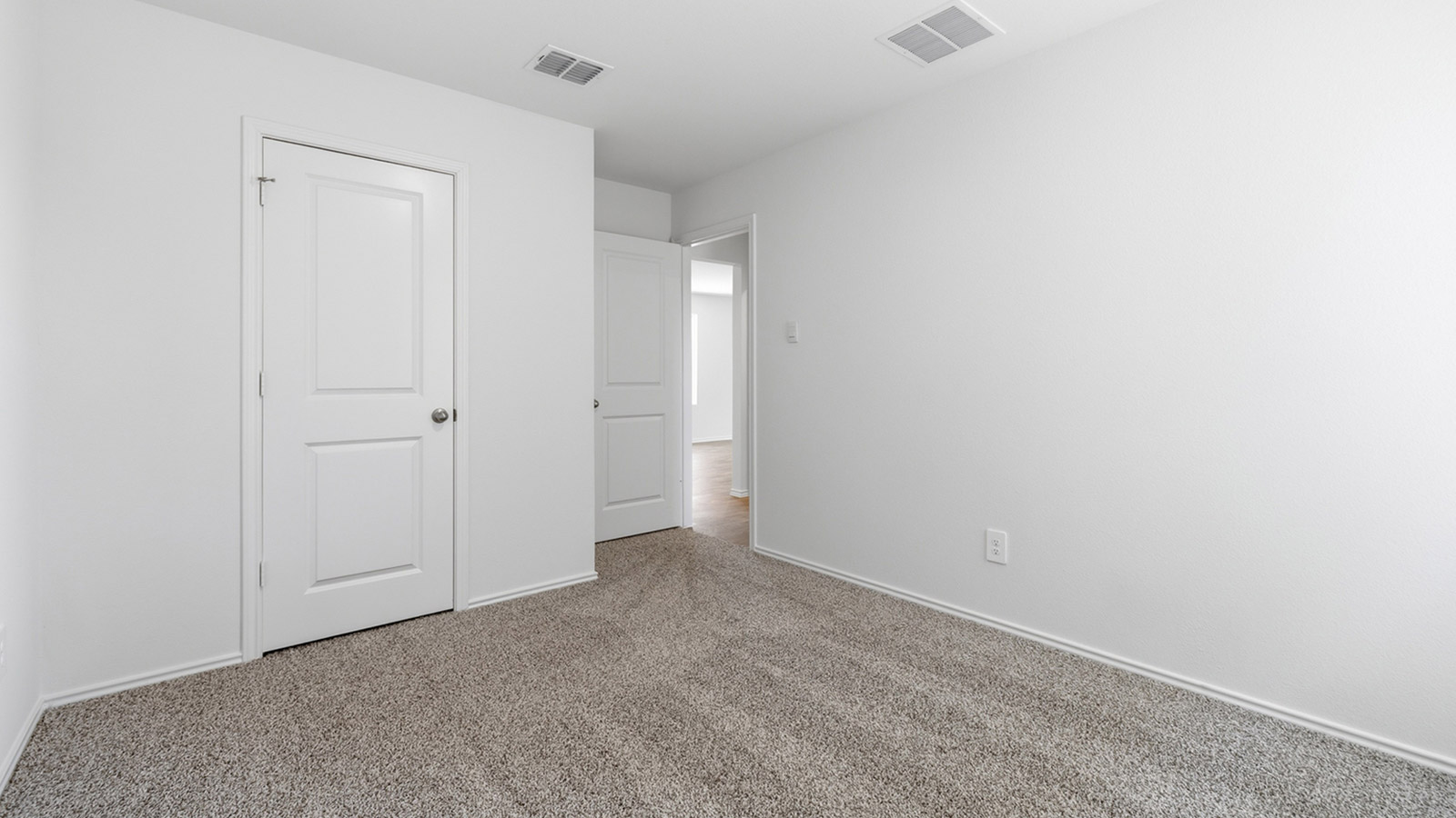 Bedroom 3 with carpeted flooring and storage closet.