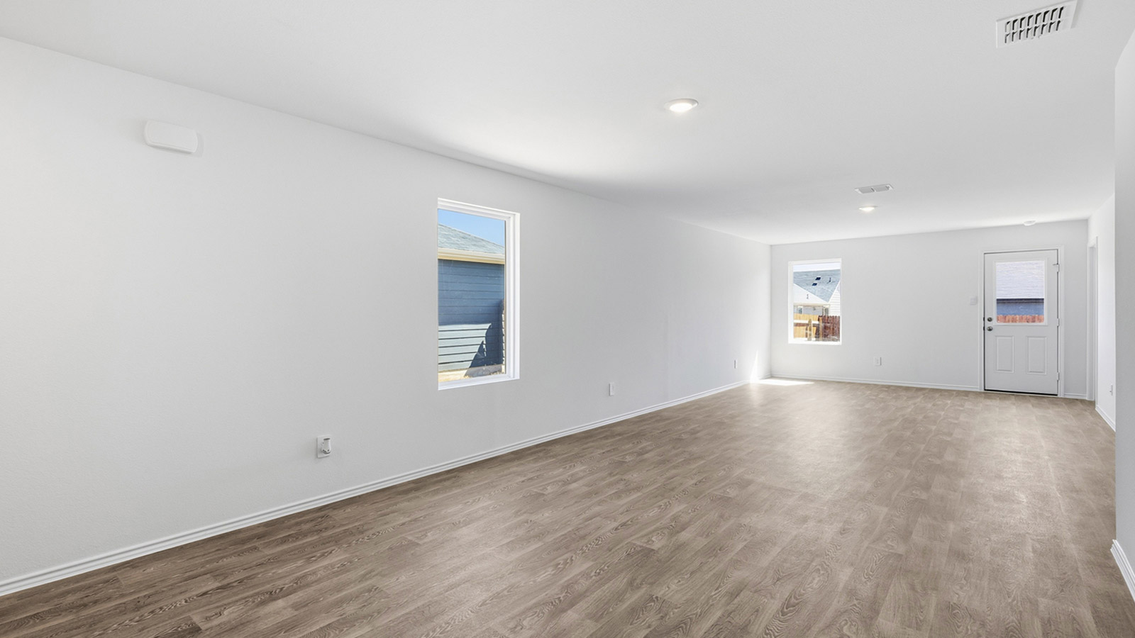 Open concept living area with vinyl flooring and window.