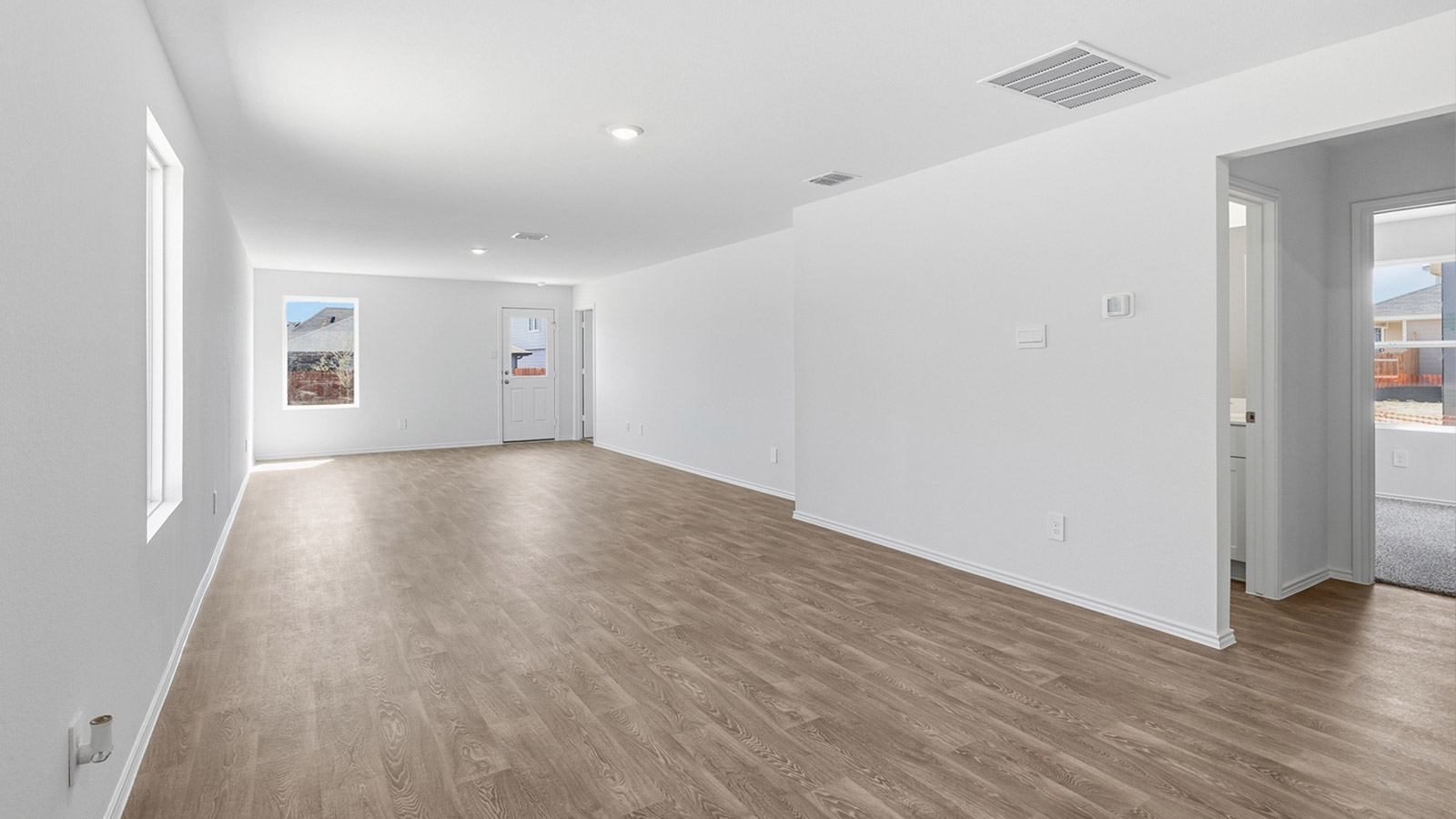 Open concept living area with vinyl flooring.