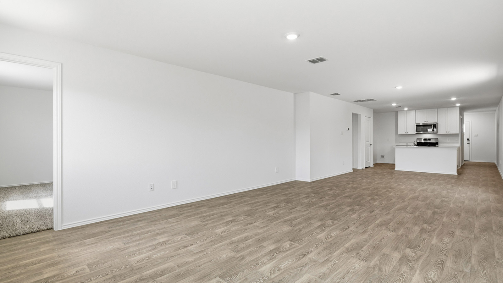 Open concept living area with vinyl flooring.