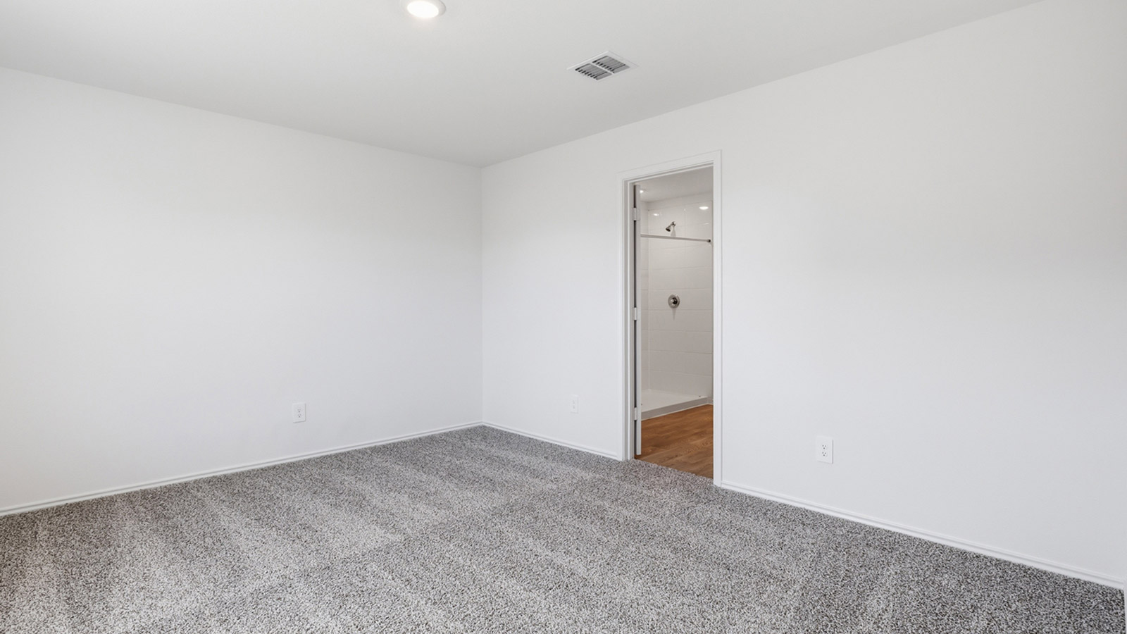 Main bedroom with carpeted flooring.