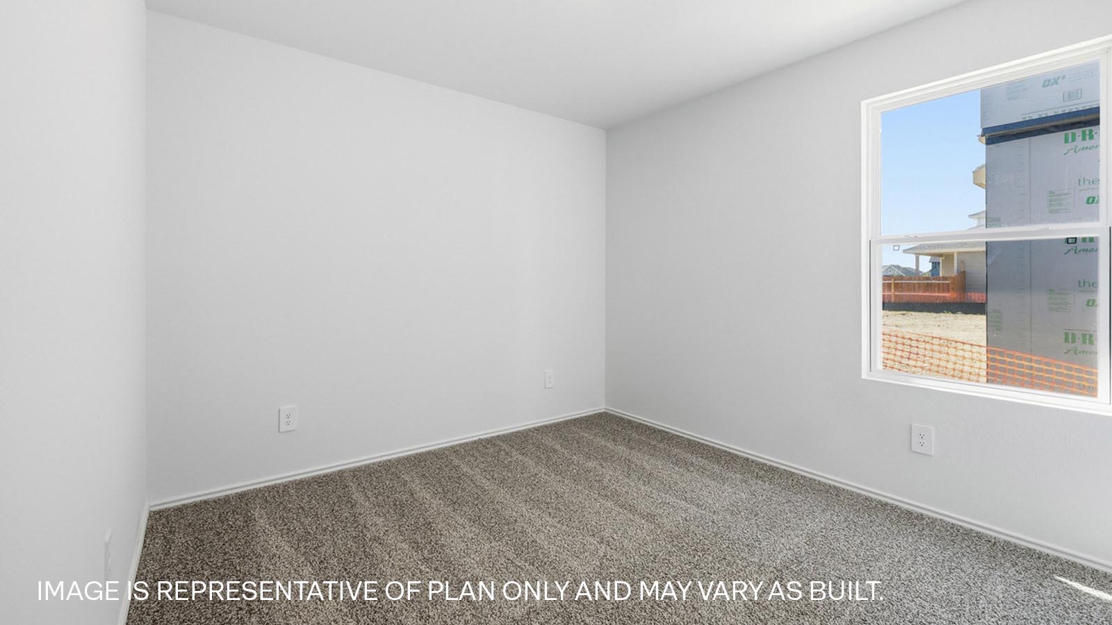 Secondary bedroom with carpeted flooring.