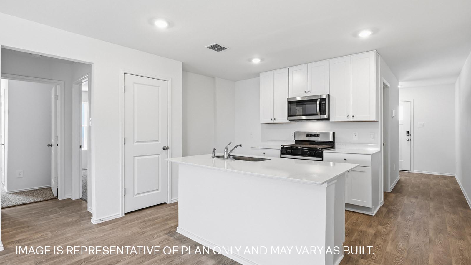 Kitchen with stainless steel range and microwave.