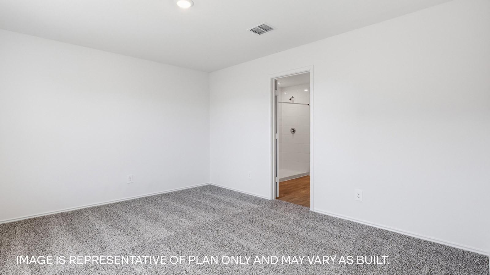 Primary bedroom with carpeted flooring.