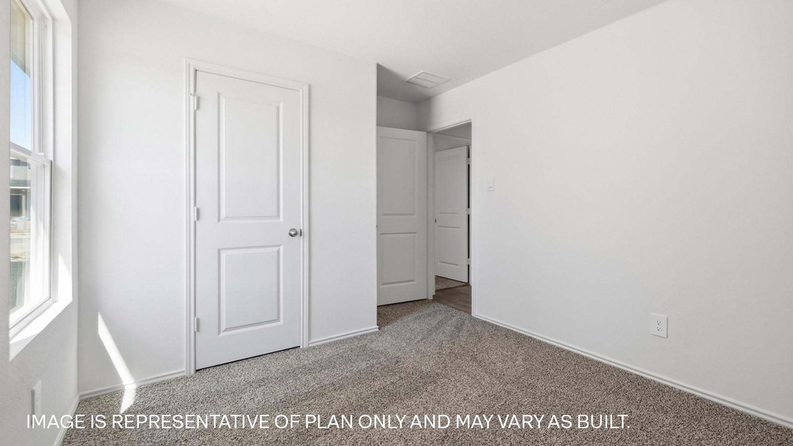 Bedroom 2 with carpeted flooring and closet.