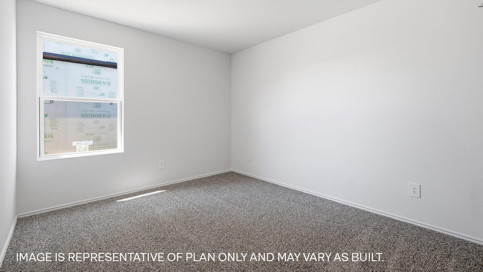 Bedroom 3 with carpeted flooring and window.