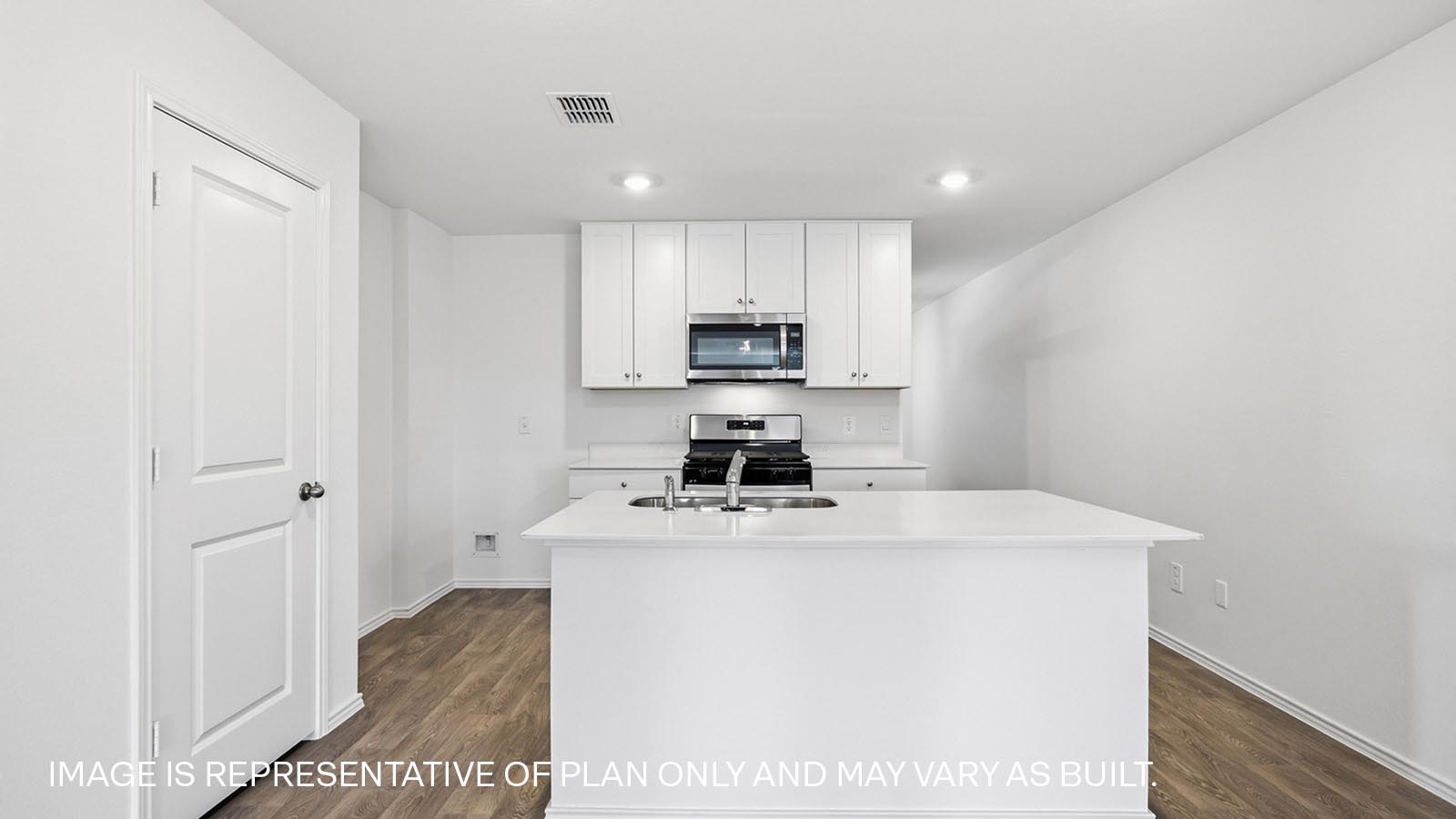 Bright and open kitchen with quartz countertops and island.