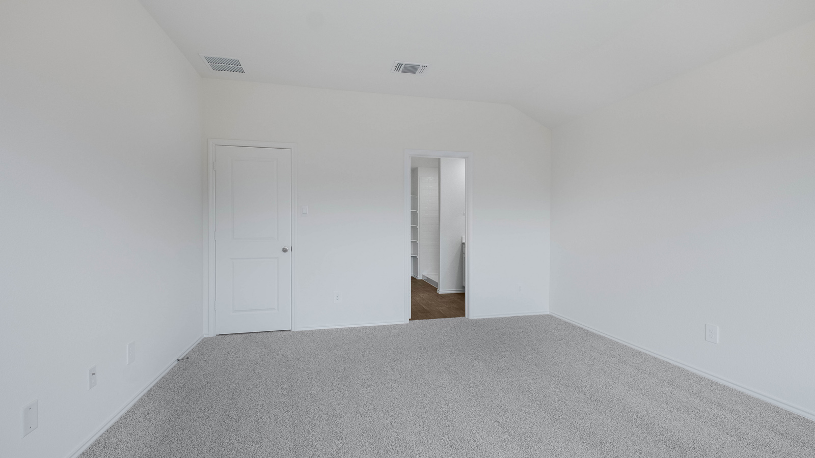 Main bedroom with carpeted flooring.