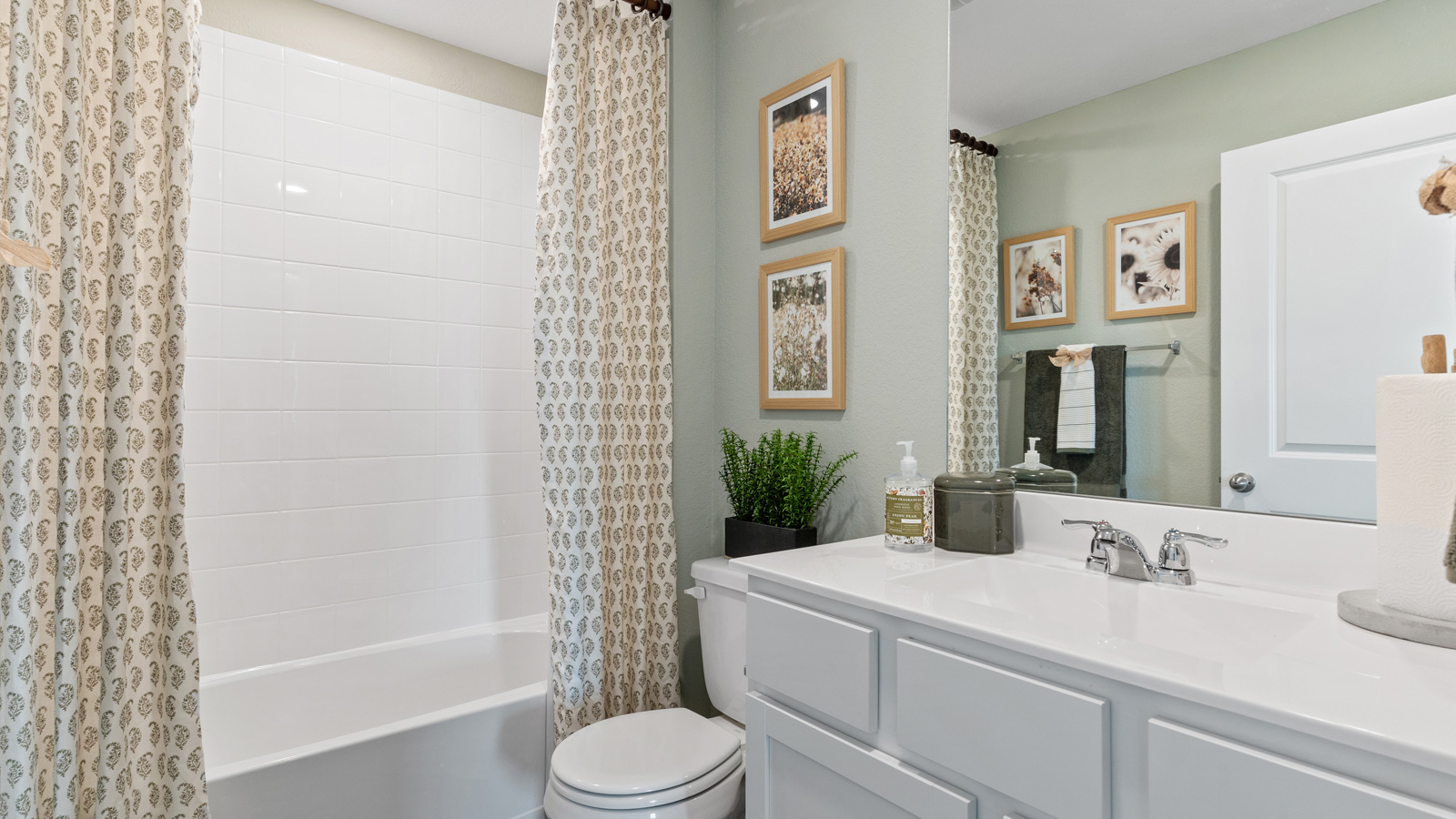 Bathroom 2 with tub and single vanity sink.