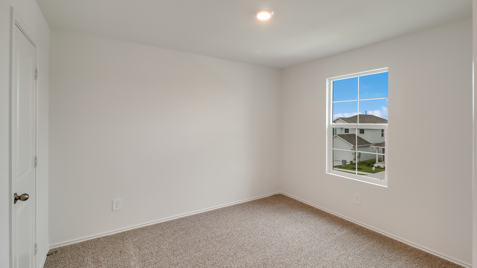 Bedroom 2 with carpeted floors, window, and closet.