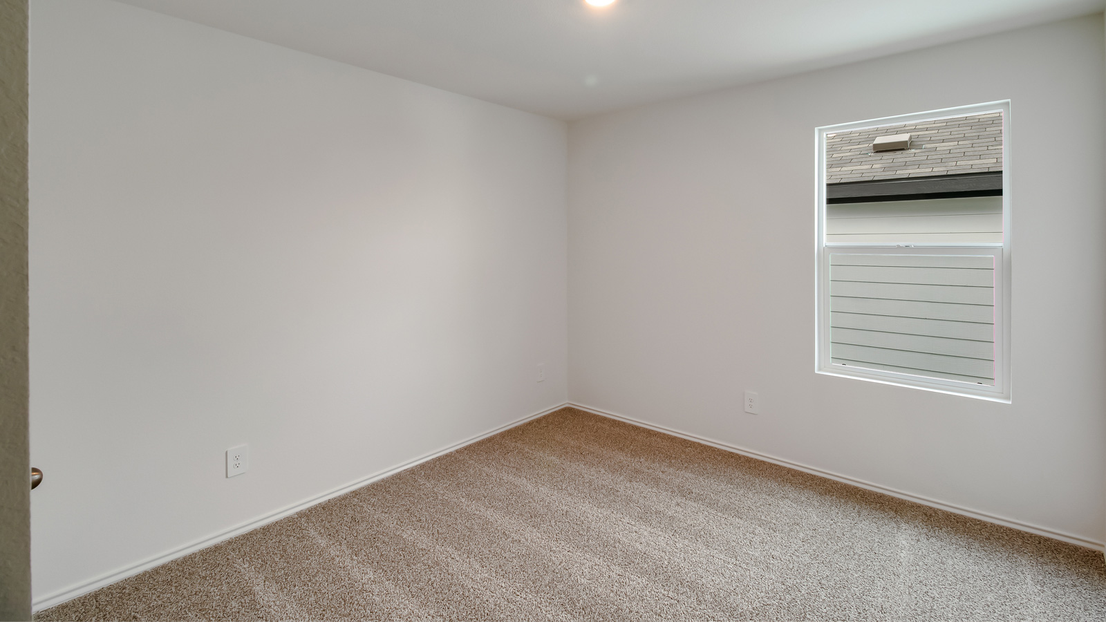 Bedroom 3 with carpeted floors, window, and closet.