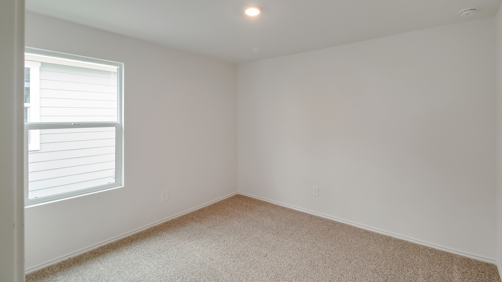 Bedroom 4 with carpeted floors, window, and closet.