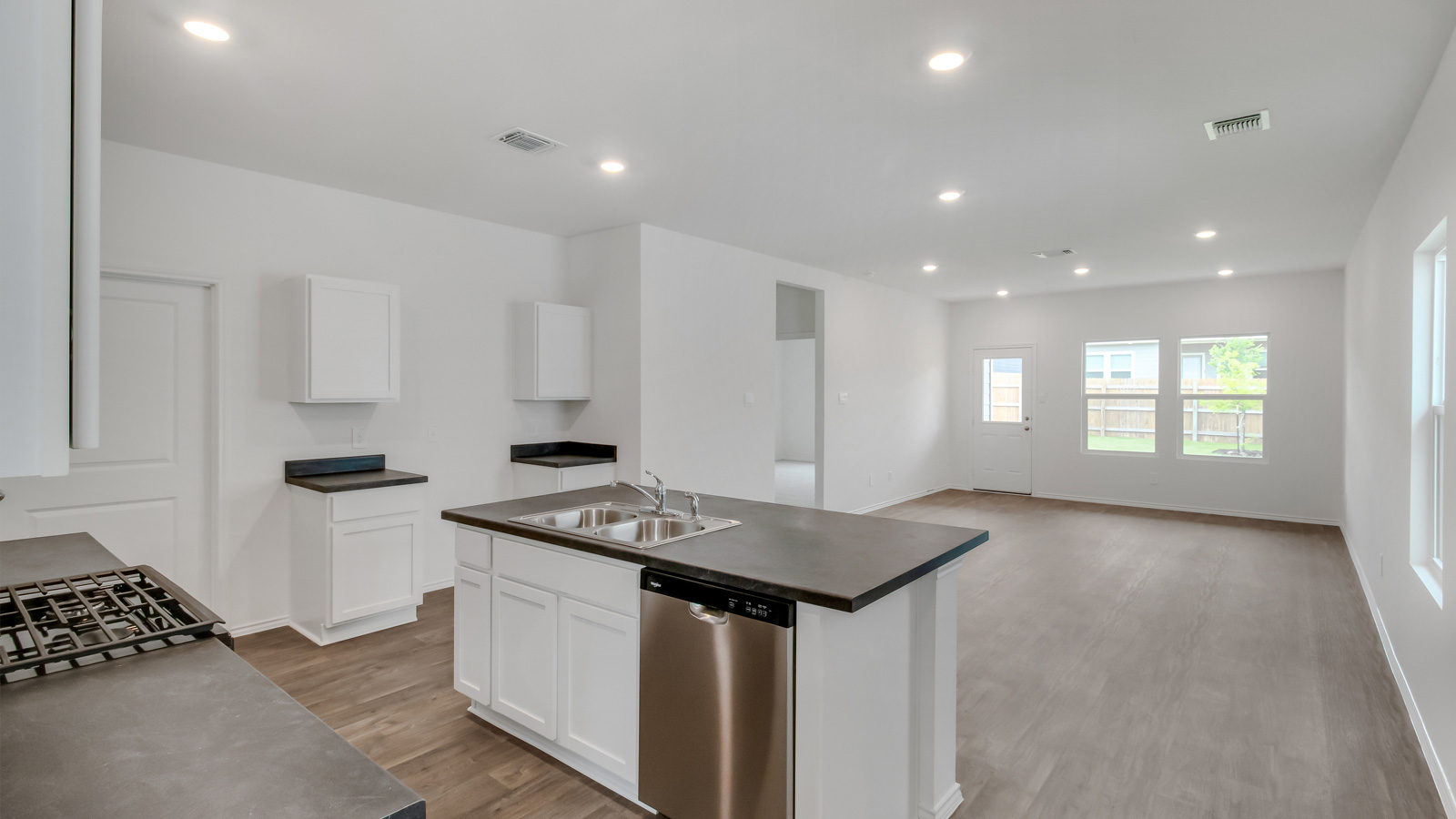 Open-concept living area and kitchen at entrance.