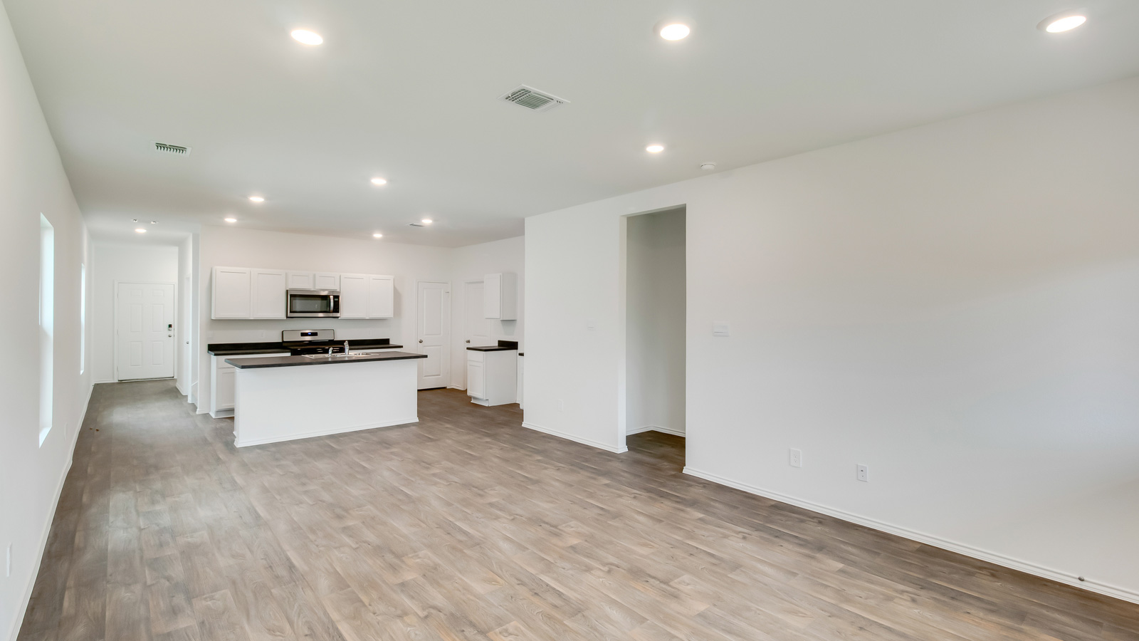 Living area with laminated wood flooring.