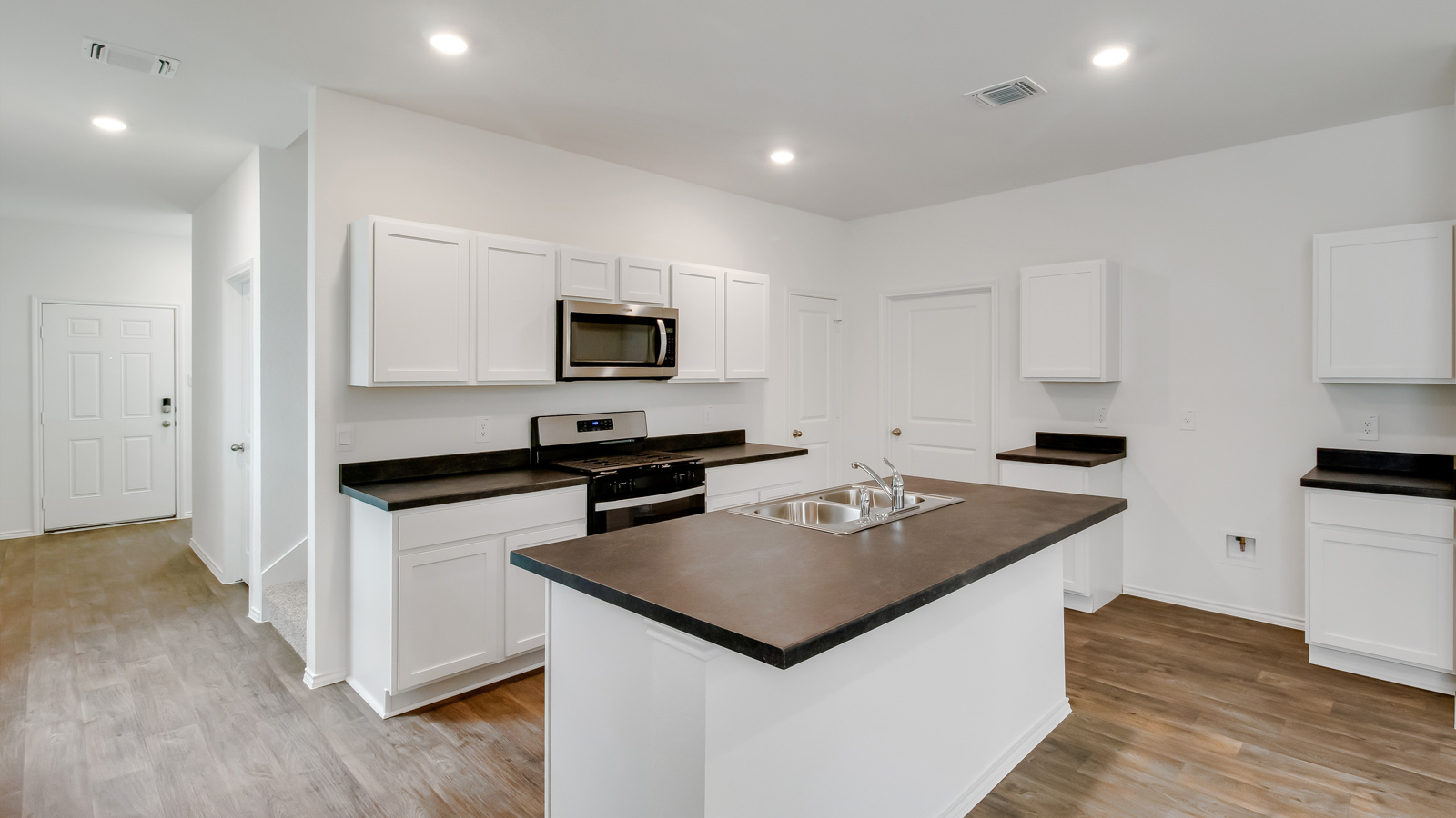 Modern kitchen with stainless steel appliances.