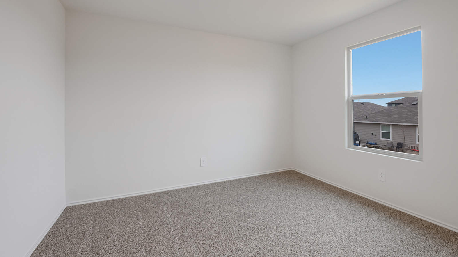 Bedroom 3 with carpted flooring and window.